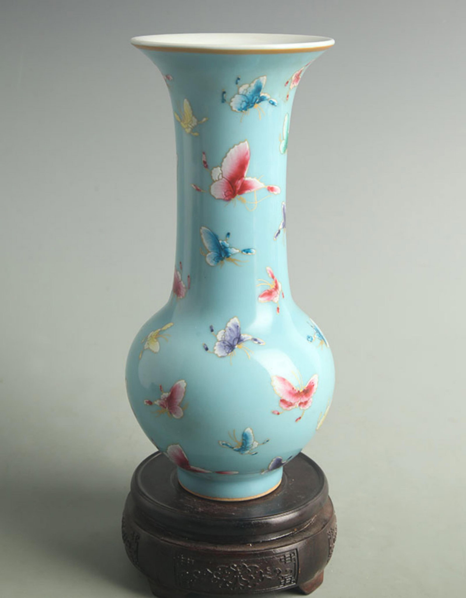 LIGHT BLUE GROUND BUTTERFLY AND FLOWER PATTERN FLOWER VASE: Qing Dynasty Qian Long Period; Diameter:High: 9.50 inch; Diameter: 4.00 inch; ;Wooden base for picture and display only.
