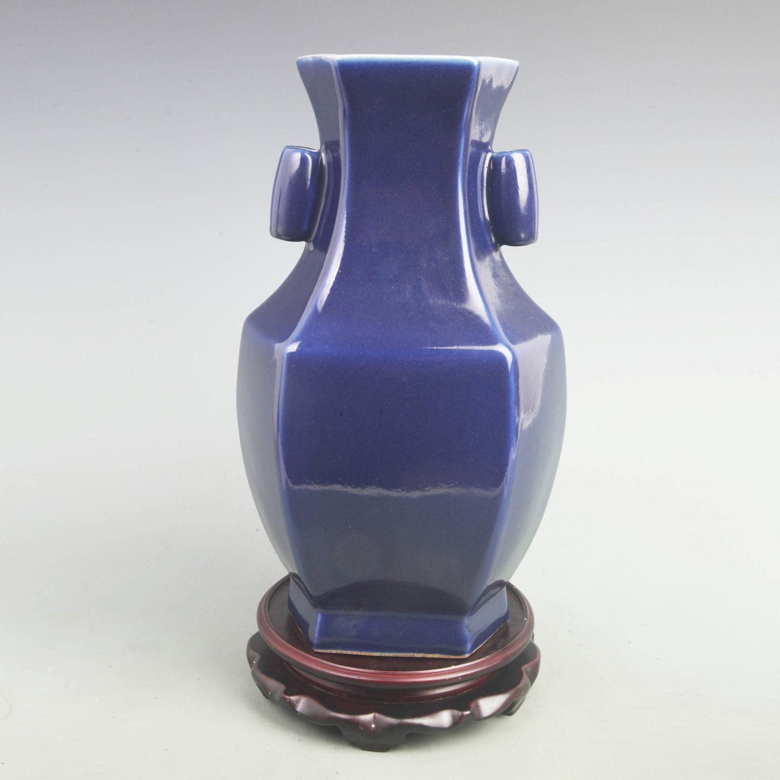 A FINE CLEAR BLUE-GLAZED DOUBLE-HANDLED HEXAGONAL PORCELAIN VESSEL: Qing Dynasty Yong Zheng Period; High: 14.5 inch; Width: 8 inch; ;Wooden base for picture and display only.