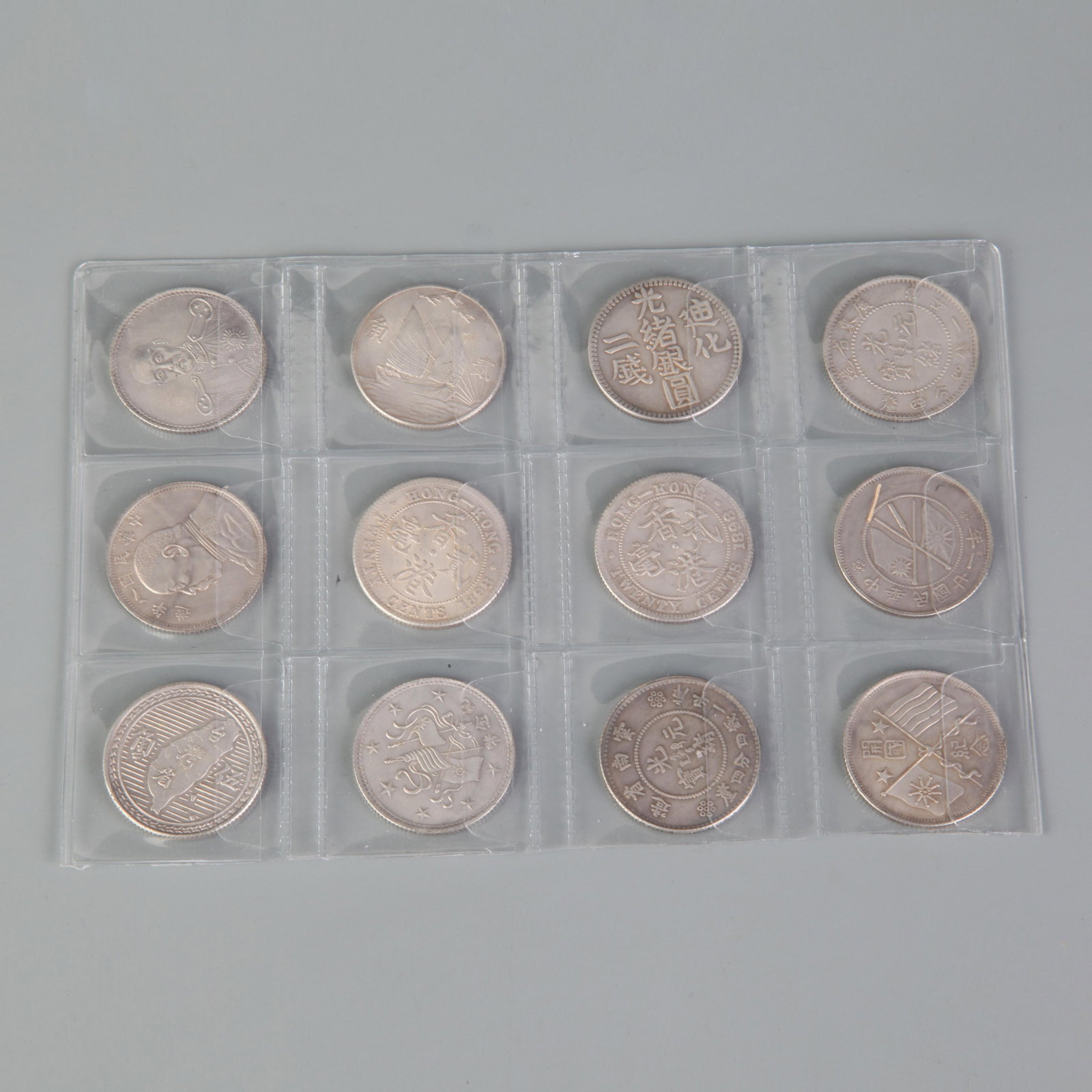 GROUP OF TWELVE SILVER DOLLARS: Republic Period; Diameter:1.0 ;Wooden base for picture and display only.