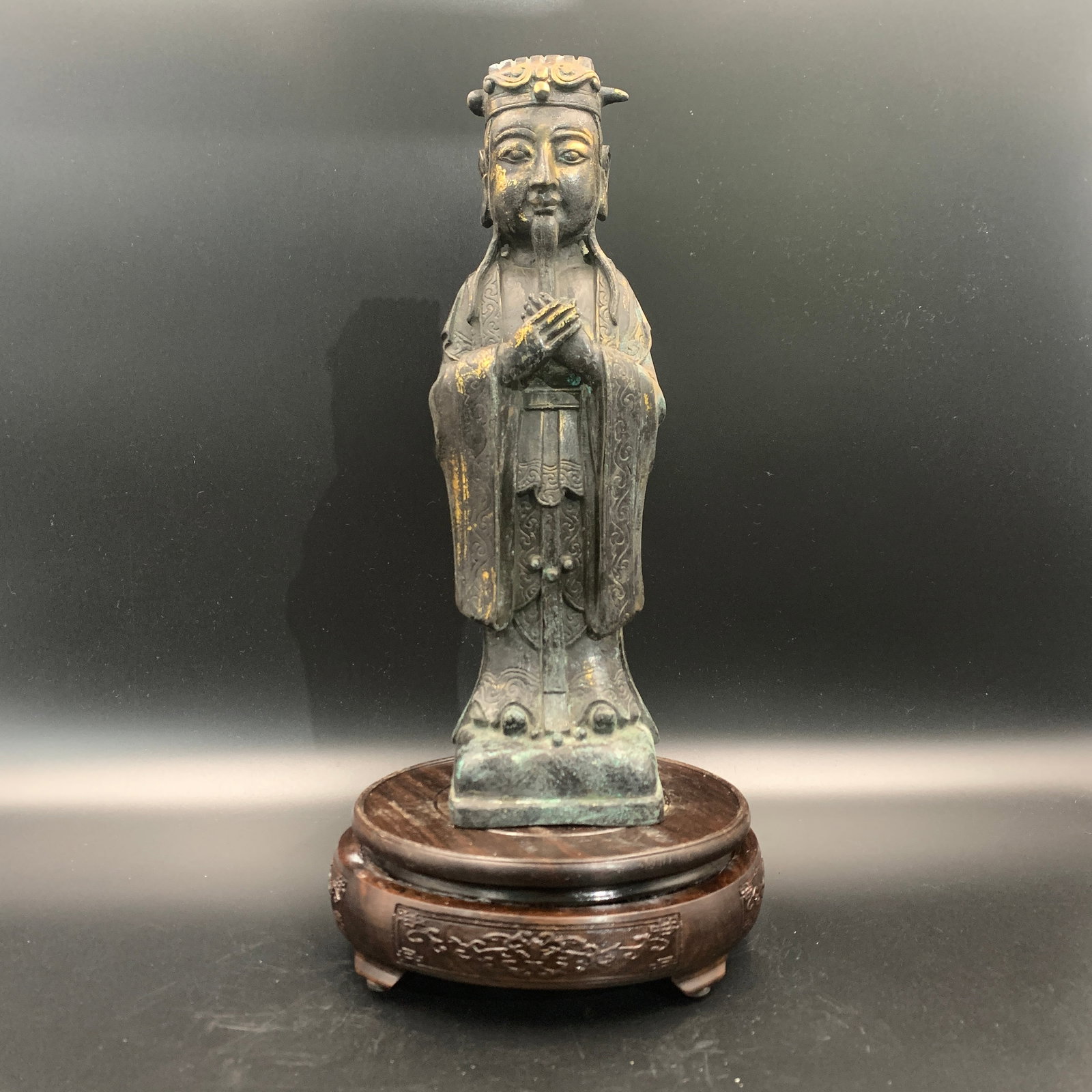GILT-BRONZE AND LACQUERED STATUE OF A TAOIST DEITY: Qing Dynasty; Long: 3.5 inch; Width: 3 inch; High: 11.5 inch; ;Wooden base for picture and display only.