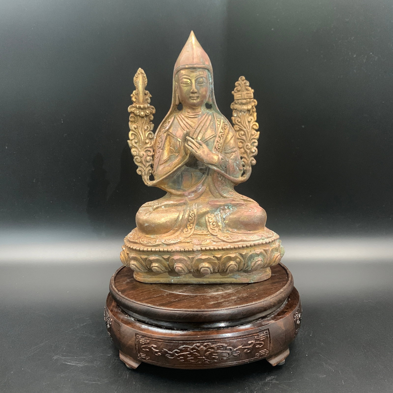 TIBETAN GILT-BRONZE SEATED FIGURE OF TSONGKHAPA ON A LOTUS THRONE: Qing Dynasty; Long: 5.5 inch; Width: 3.1 inch; High: 5.3 inch; ;Wooden base for picture and display only.