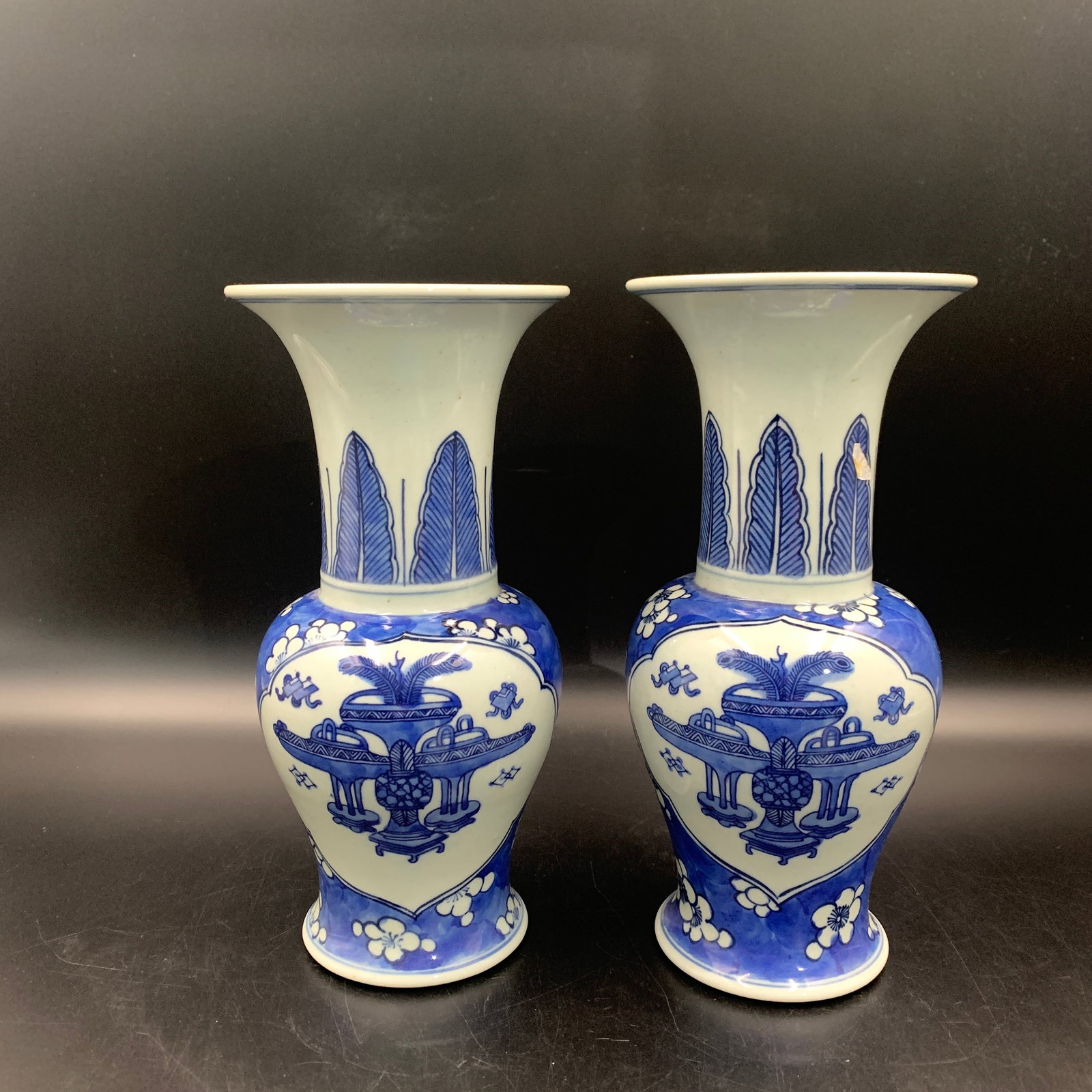 PAIR OF BLUE AND WHITE RUYI-PANEL FLOWER-VESSEL PATTERN VASES: Qing Dynasty; Long: 9.6 inch; Width: 4.3 inch; ;Wooden base for picture and display only.