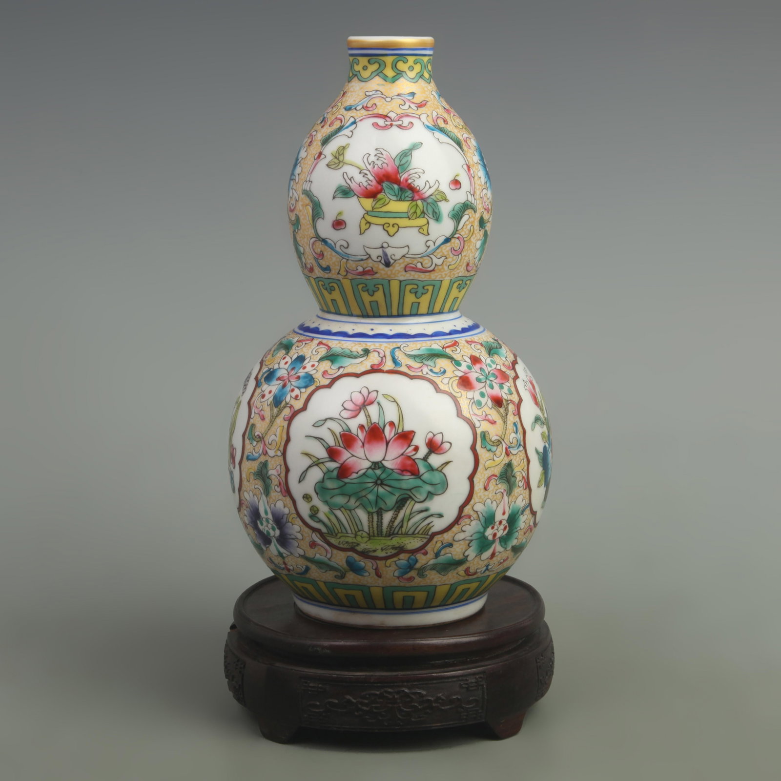 FAMILLE ROSE FLOWER PATTERN CALABASH SHAPED VASE: Qing Dynasty Qianlong Period; High: 9.5 inch; Width: 5.5 inch; ;Wooden base for picture and display only.