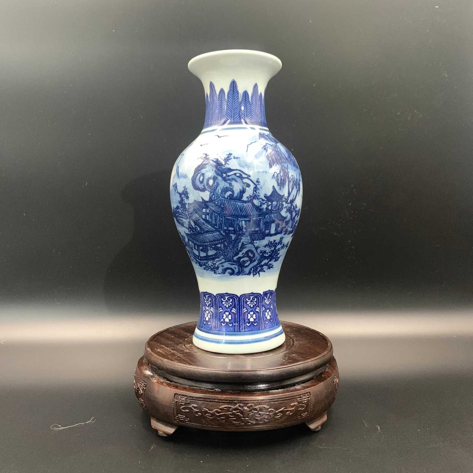 BLUE AND WHITE LANDSCAPE PATTERN BALUSTER VASE: Qing Dynasty; High: 8.9 inch; Diameter: 4.3 inch; ;Wooden base for picture and display only.