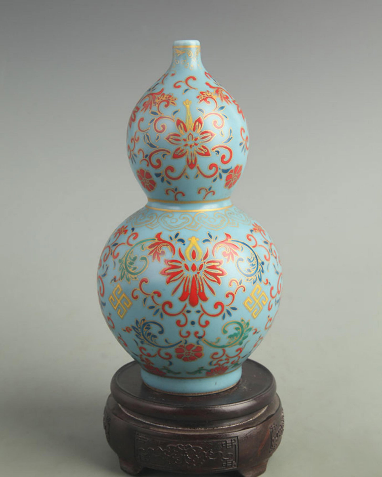 BLUE GROUND FLOWER GOURD VASE: Qing Dynasty Yong Zheng Period; High: 9.30 inch; Width: 4.80 inch ;Wooden base for picture and display only.