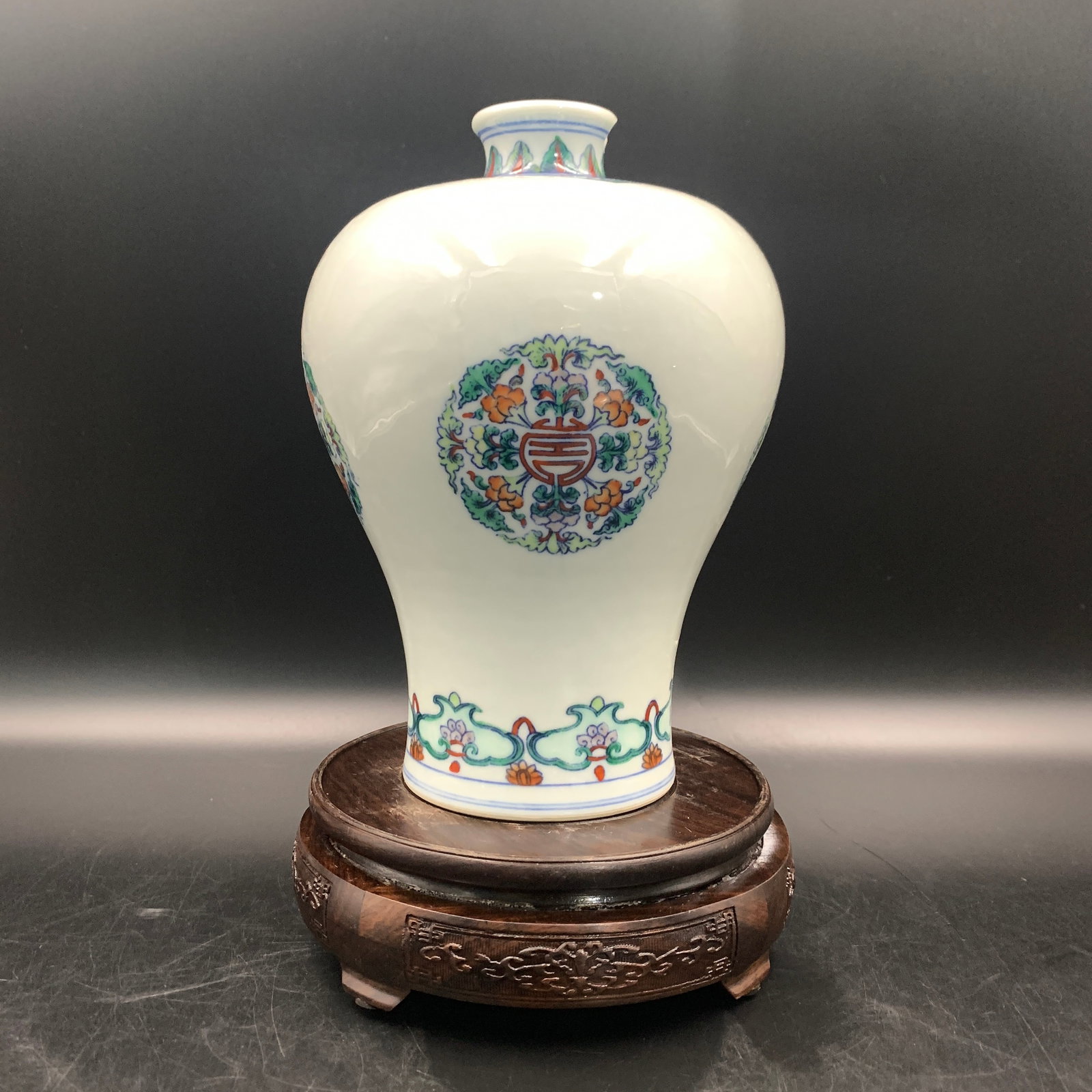 DOUCAI FLORAL MEDALLION AND SHOU CHARACTER PATTERN MEIPING VASE: Qing Dynasty; High: 8.5 inch; Diameter: 6 inch; ;Wooden base for picture and display only.