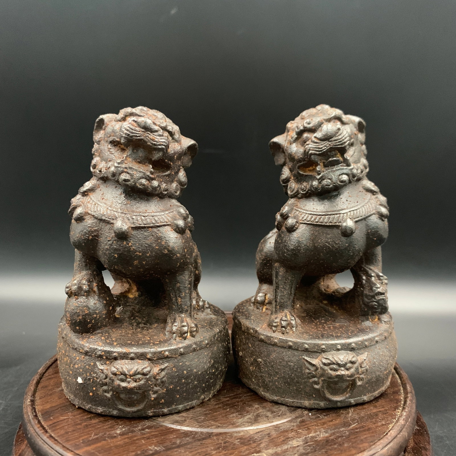 PAIR OF CAST IRON BUDDHIST GUARDIAN LIONS FIGURE: Qing Dynasty; Long: 2.7 inch; Width: 2.7 inch; High: 4.3 inch; ;Wooden base for picture and display only.