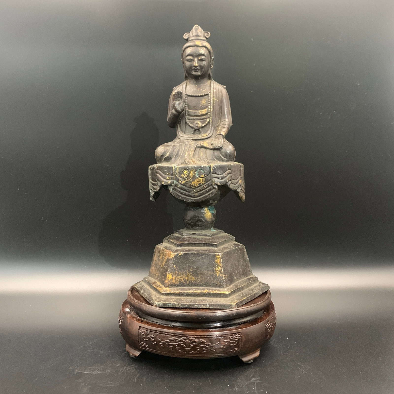 GILT-BRONZE SEATED BODHISATTVA ON A HIGH PEDESTAL: Ming Dynasty Style; High: 11.3 inch; Diameter: 5.9 inch; ;Wooden base for picture and display only.
