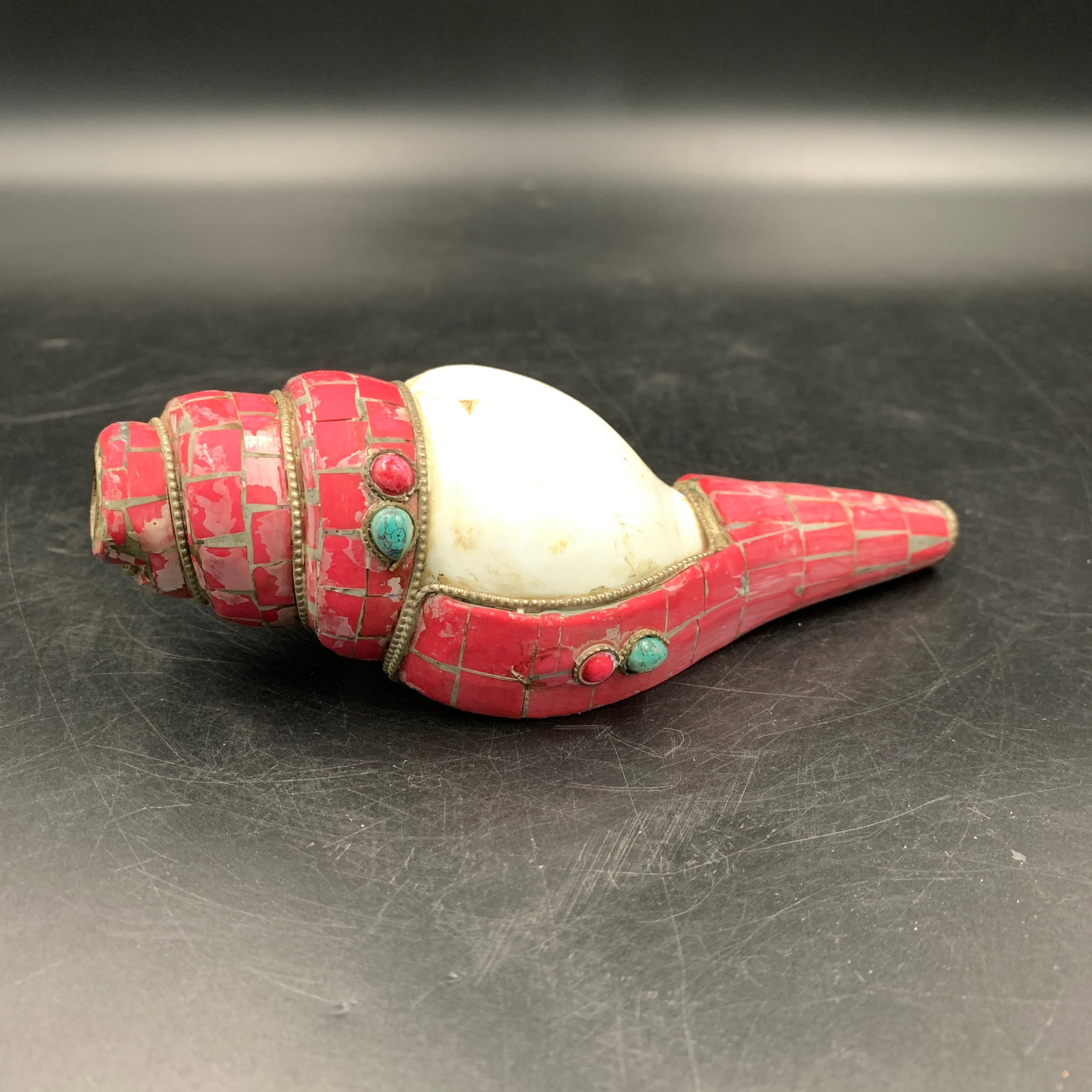 TIBETAN BUDDHIST CORAL AND TURQUOISE INLAID RITUAL CONCH SHELL: Qing Dynasty; Long: 6.1 inch; Width: 2.3 inch; High: 1.9 inch; ;Wooden base for picture and display only.