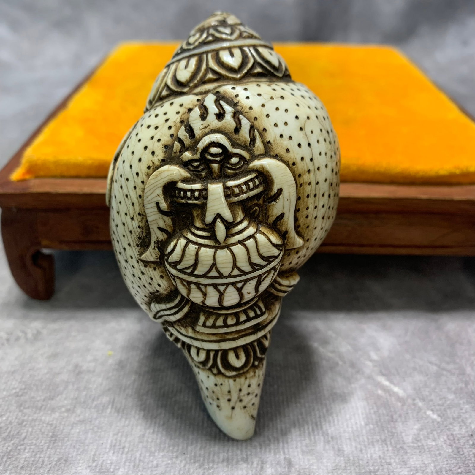 TIBETAN CARVED CONCH SHELL RITUAL SHANKHA WITH TREASURE: Qing Dynasty; Long: 14 inch; Width: 2.2 inch; High: 2 inch ;Wooden base for picture and display only.