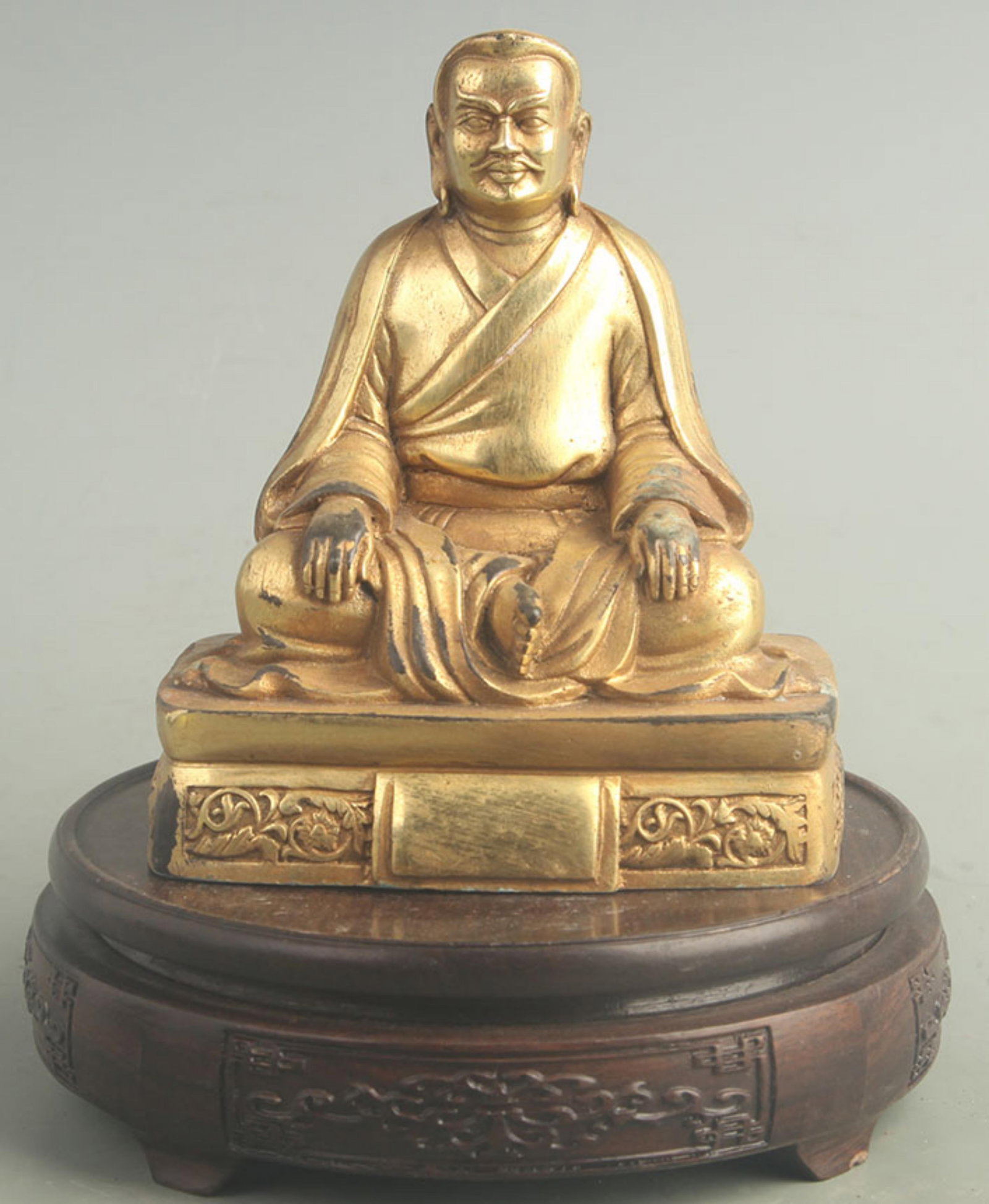 A GILT-BRONZE SEATED ARHAT FIGURE, TIBETAN BUDDHISM: 20th Century; High: 5.50 inch; Width: 3.50 inch; Long: 5.00 inch ;Wooden base for picture and display only.