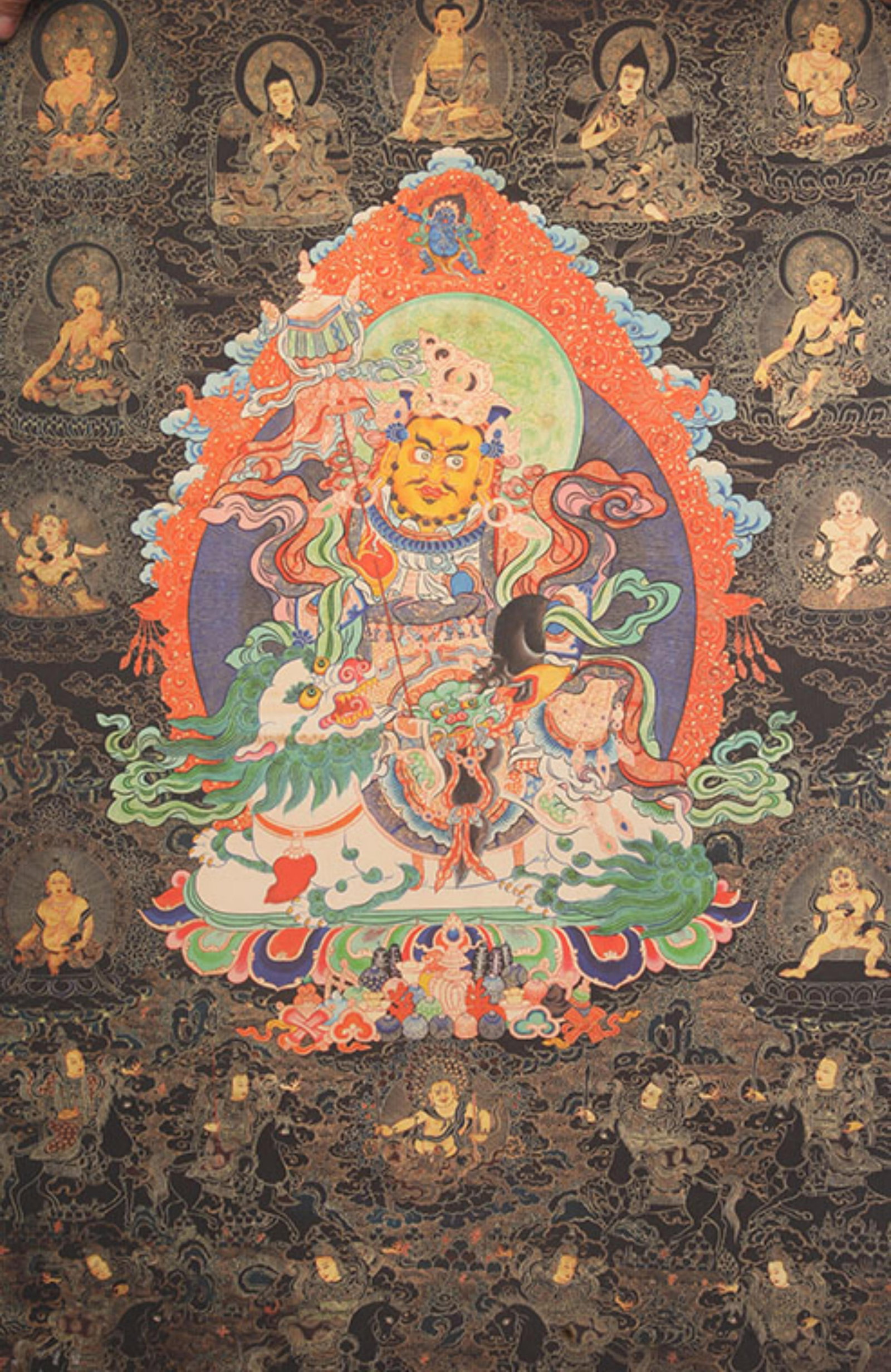 TIBETAN THANGKA PAINTING OF VAISHRAVANA KING OF THE NORTH ON A WHITE LION: 20th Century; High: 35.0 inch; Width: 23.0 inch ;Wooden base for picture and display only.