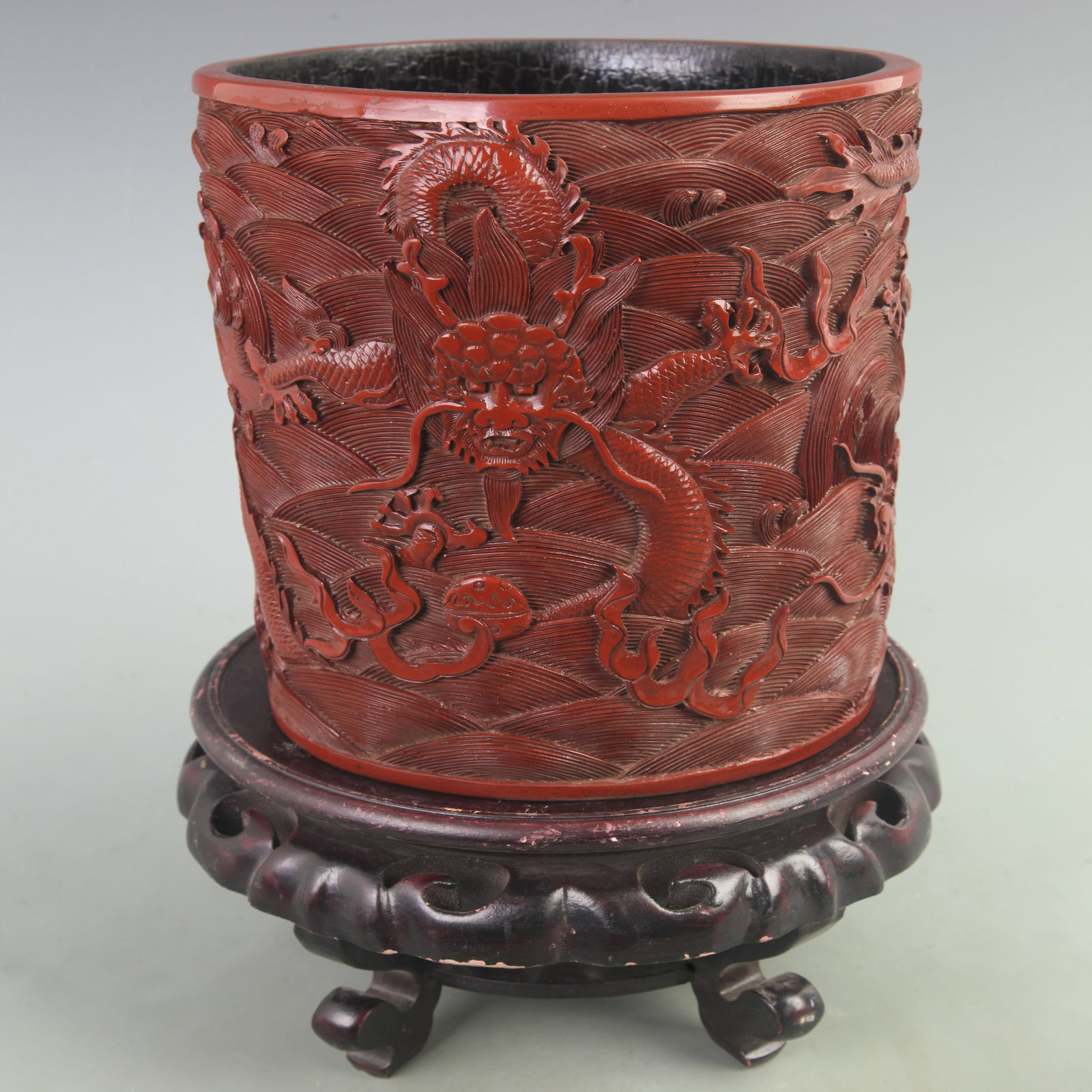 CARVED RED LACQUER ROUND PEN HOLDER WITH DRAGON MOTIF: Ming Dynasty Style; High: 9 inch; Diameter: 7.2 inch; ;Wooden base for picture and display only.