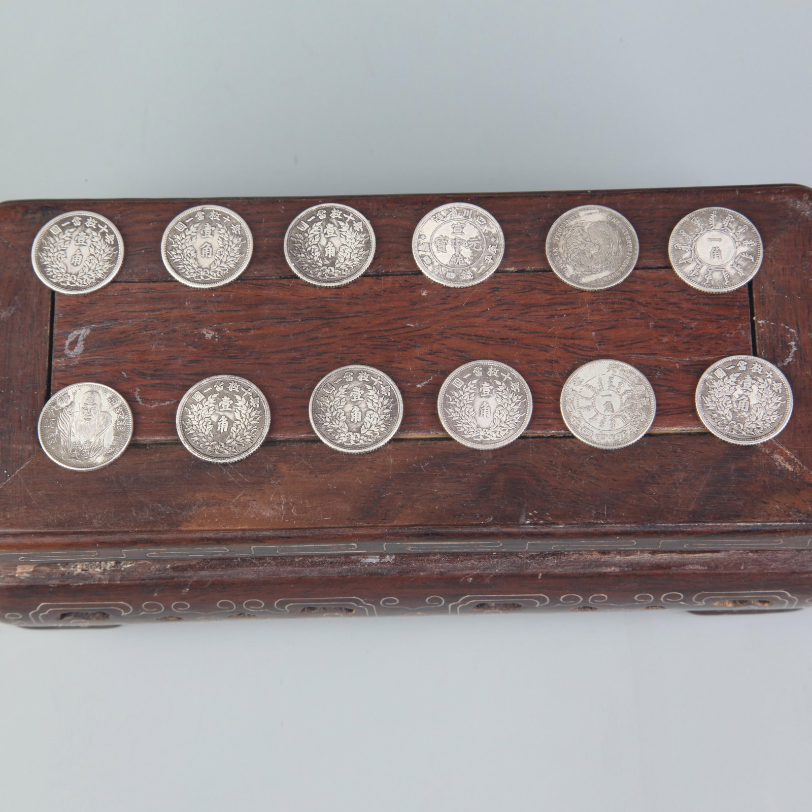 GROUP OF TWELVE REPUBLIC OF CHINA DOLLARS: Republic Period; Diameter: 0.7 inch ;Wooden base for picture and display only.
