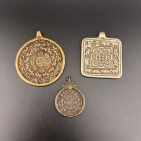 GROUP OF THREE STAMPED METAL PROTECTIVE MELONG PLATES