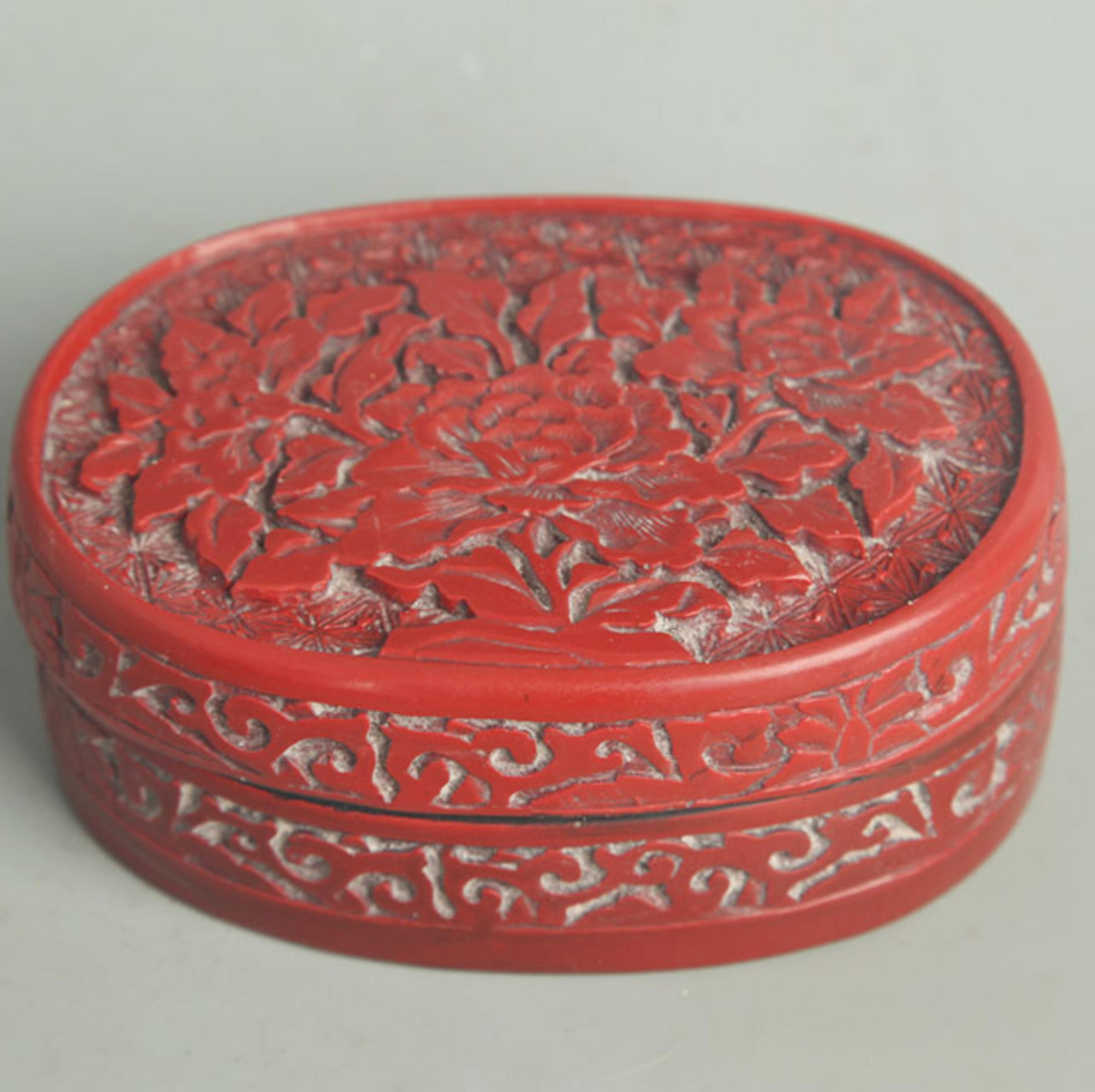 CARVED RED LACQUER FLORAL INCENSE BOX: Qing Dynasty; High: 2.00 inch; Width: 3.50 inch; Long: 4.75 inch ;Wooden base for picture and display only.