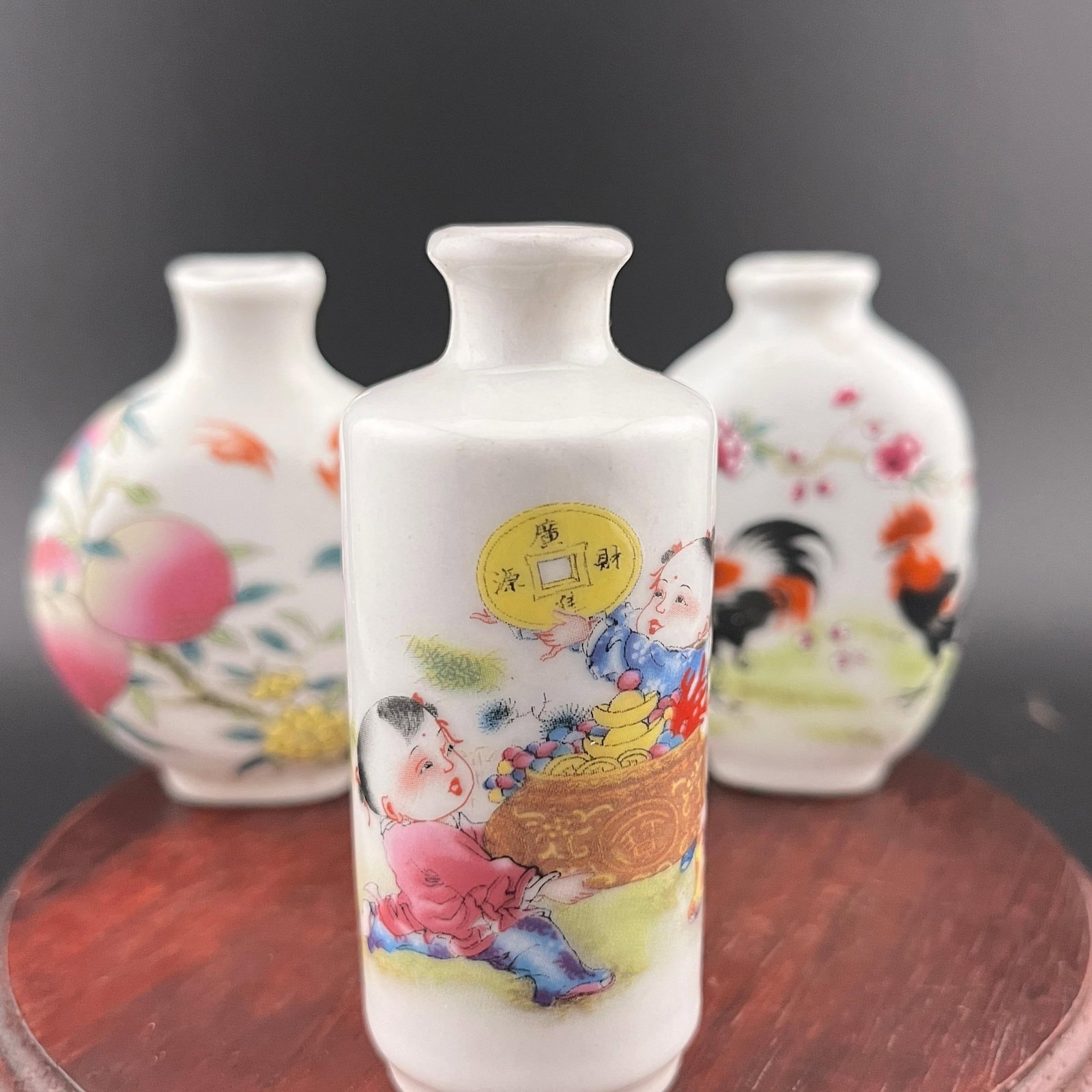 GROUP OF THREE FAMILLE ROSE PORCELAIN SNUFF BOTTLE: Modern; High: 3 inch; Diameter: 1.25 inch; Long: 2.17 inch; Width: 0.92 inch; High: 2.72 inch; ;Wooden base for picture and display only.