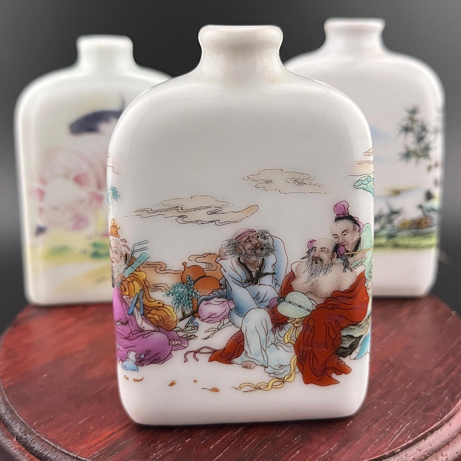 GROUP OF THREE FAMILLE ROSE PORCELAIN SNUFF BOTTLE: Modern; Long: 2.1 inch; Width: 0.84 inch; High: 3.1 inch; Long: 2.1 inch; Width: 0.84 inch; High: 3.1 inch; Long: 1.93 inch; Width: 0.7 inch; High: 2.93 inch; ;Wooden base for picture and display only