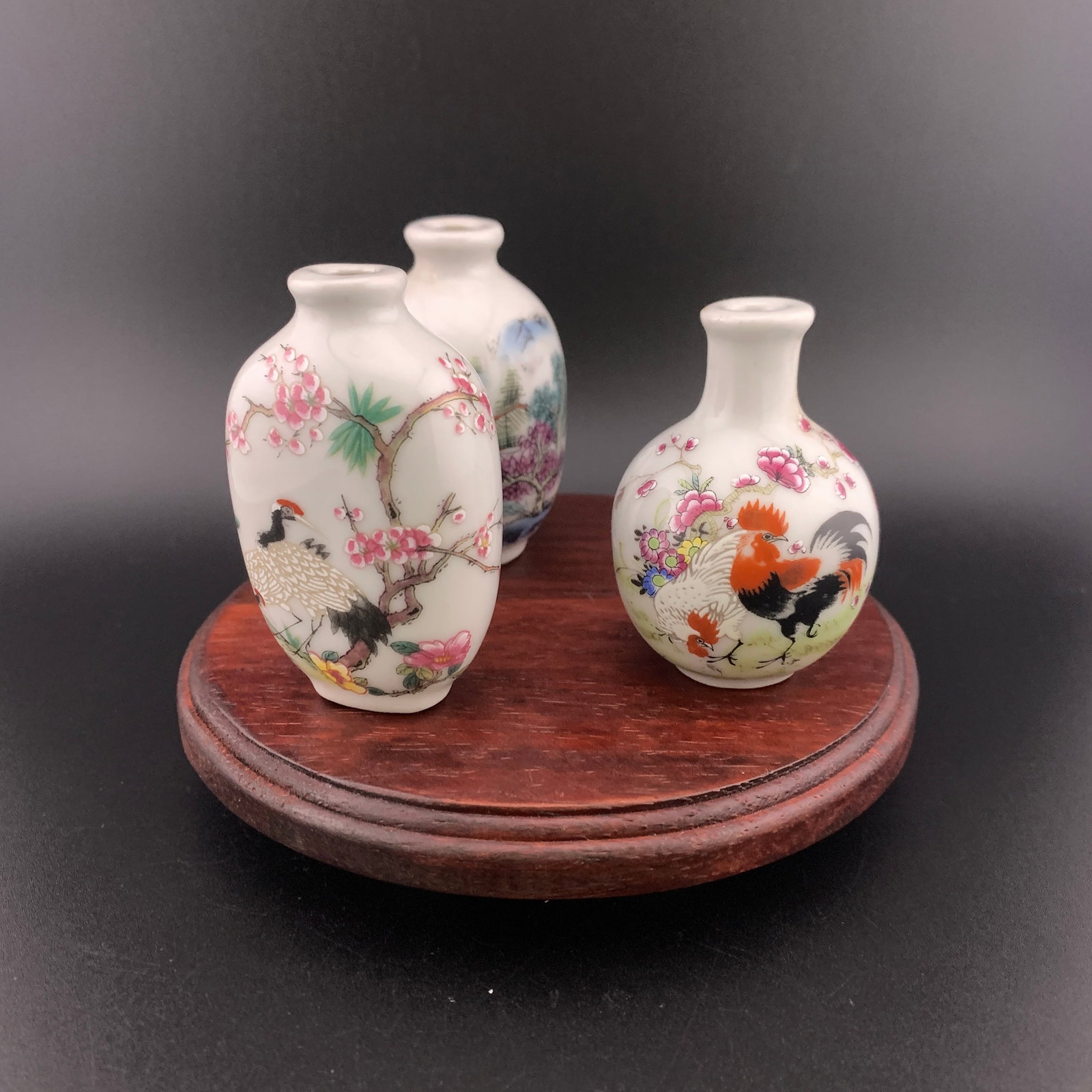 GROUP OF THREE FAMILLE ROSE PORCELAIN SNUFF BOTTLE: Modern; High: 2.4 inch; Diameter: 1.65 inch; High: 2.68 inch; Diameter: 1.65 inch; Long: 1.68 inch; Width: 1.1 inch; High: 2.7 inch; ;Wooden base for picture and display only.