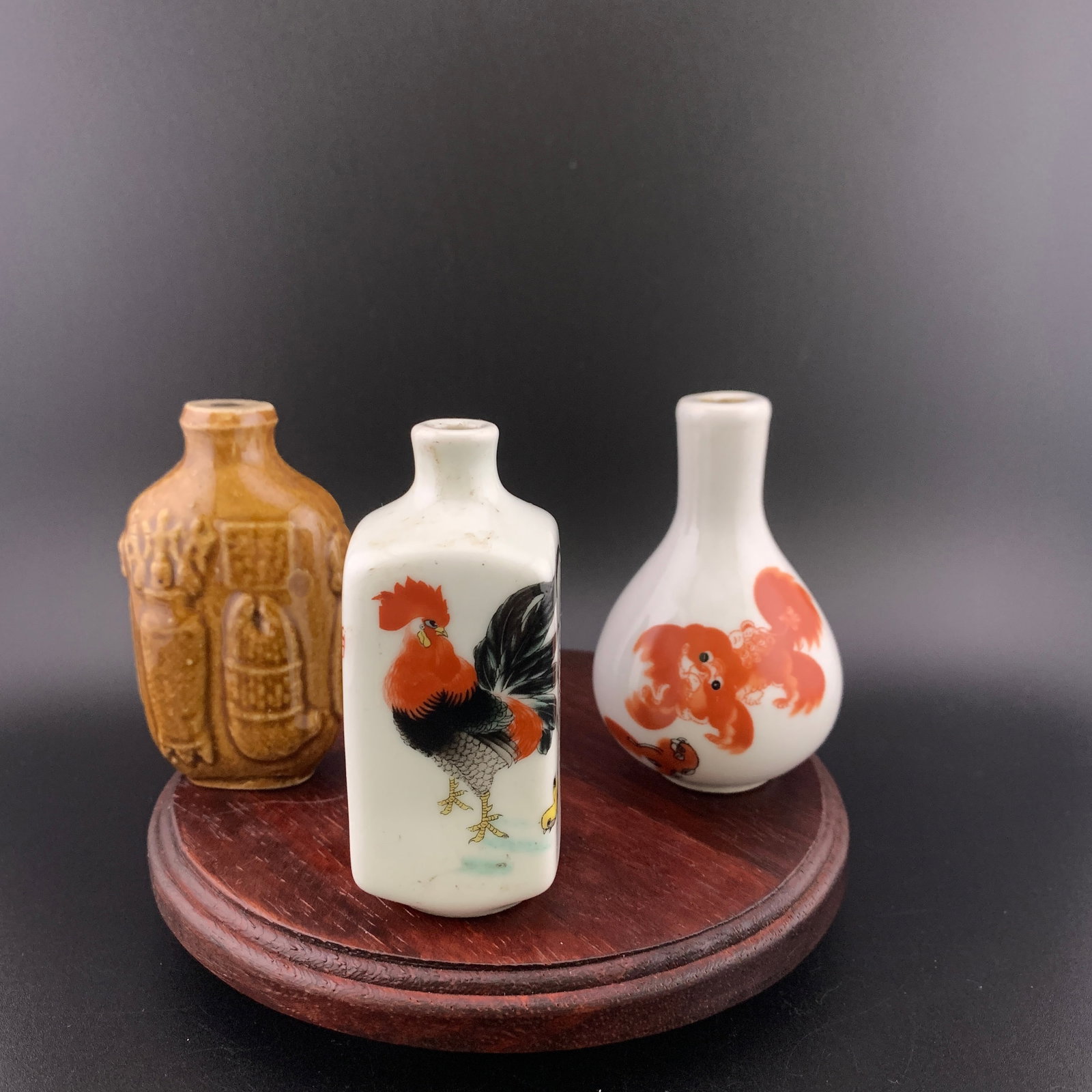 GROUP OF THREE FAMILLE ROSE PORCELAIN SNUFF BOTTLE: Modern; Long: 1.7 inch; Width: 0.91 inch; High: 2.82 inch; Long: 1.28 inch; Width: 1.24 inch; High: 3 inch; High: 2.9 inch; Diameter: 1.83 inch; ;Wooden base for picture and display only.