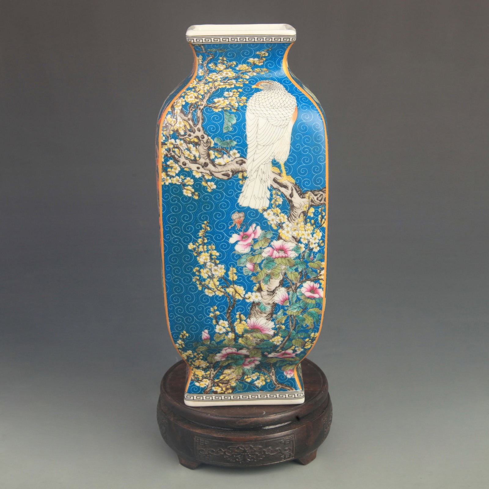 FAMILLE ROSE GLAZED BLUE GROUND BIRD AND FLOWER SQUARE VASE: Qing Dynasty Qian Long Period;High: 11.0 inch; Diameter: 4.80 inch ;Wooden base for picture and display only.
