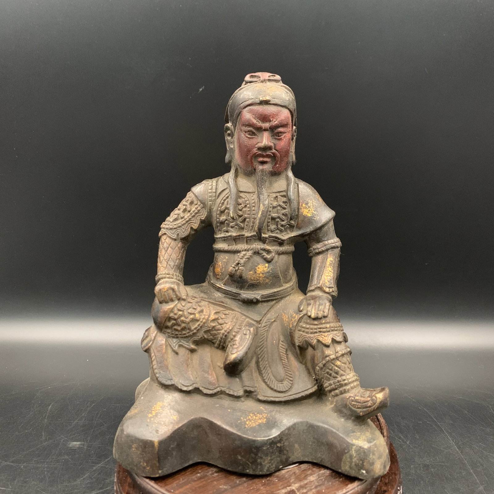 A CHINESE BRONZE MARTIAL DEITY STATUE OF GENERAL GUANDI: Qing Dynasty; Long: 5.8 inch; Width: 4.3 inch; High: 8 inch; ;Wooden base for picture and display only.