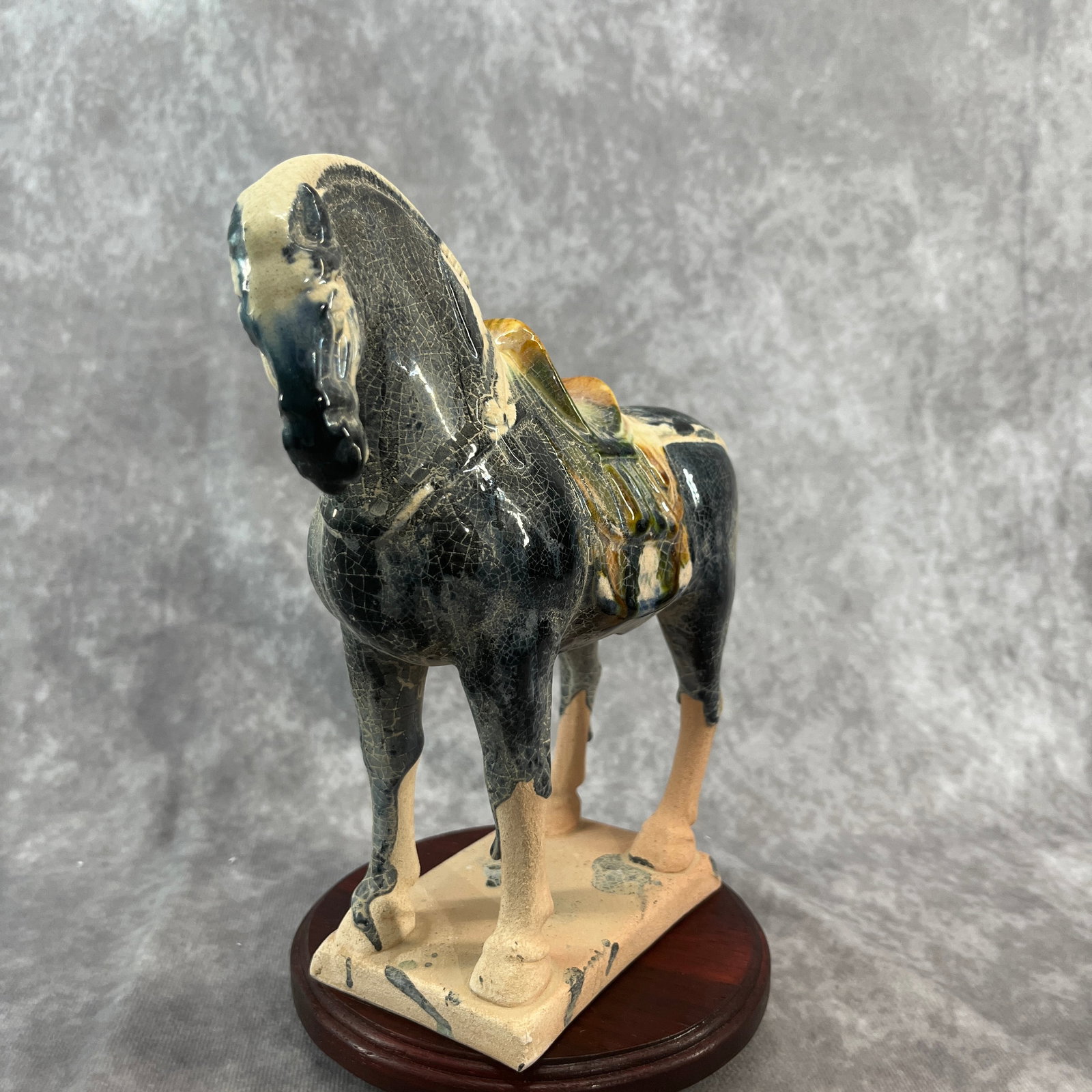 A SANCAI-GLAZED POTTERY FIGURE OF A STANDING HORSE WITH DARK BLUE-BLACK GLAZE: Tang Dynasty Style; Long: 8.1 inch; Width: 2.8 inch; High: 7.9 inch; ;Wooden base for picture and display only.