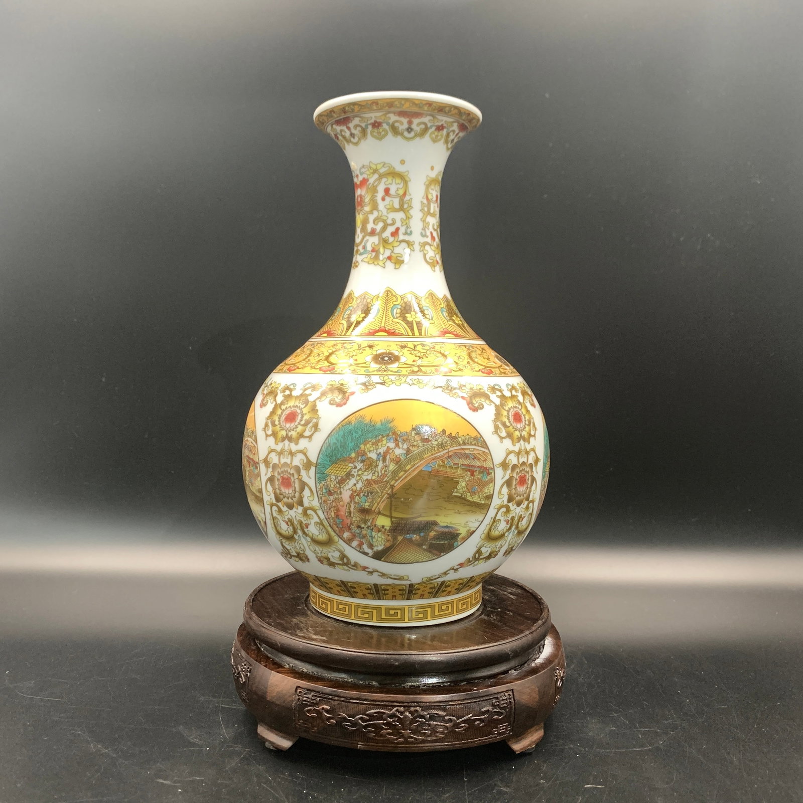 A FAMILLE-ROSE VASE PAINTED WITH FESTIVAL SCENES: Qing Dynasty; High: 9.6 inch; Diameter: 6.2 inch; ;Wooden base for picture and display only.