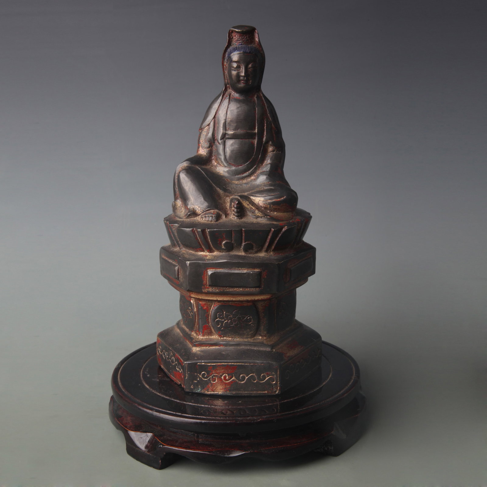 A LACQUERED AND GILT BRONZE FIGURE OF GUANYIN ON A HEXAGONAL THRONE: Qing Dynasty; Width: 4.8 inch; High: 9.2 inch ;Wooden base for picture and display only.