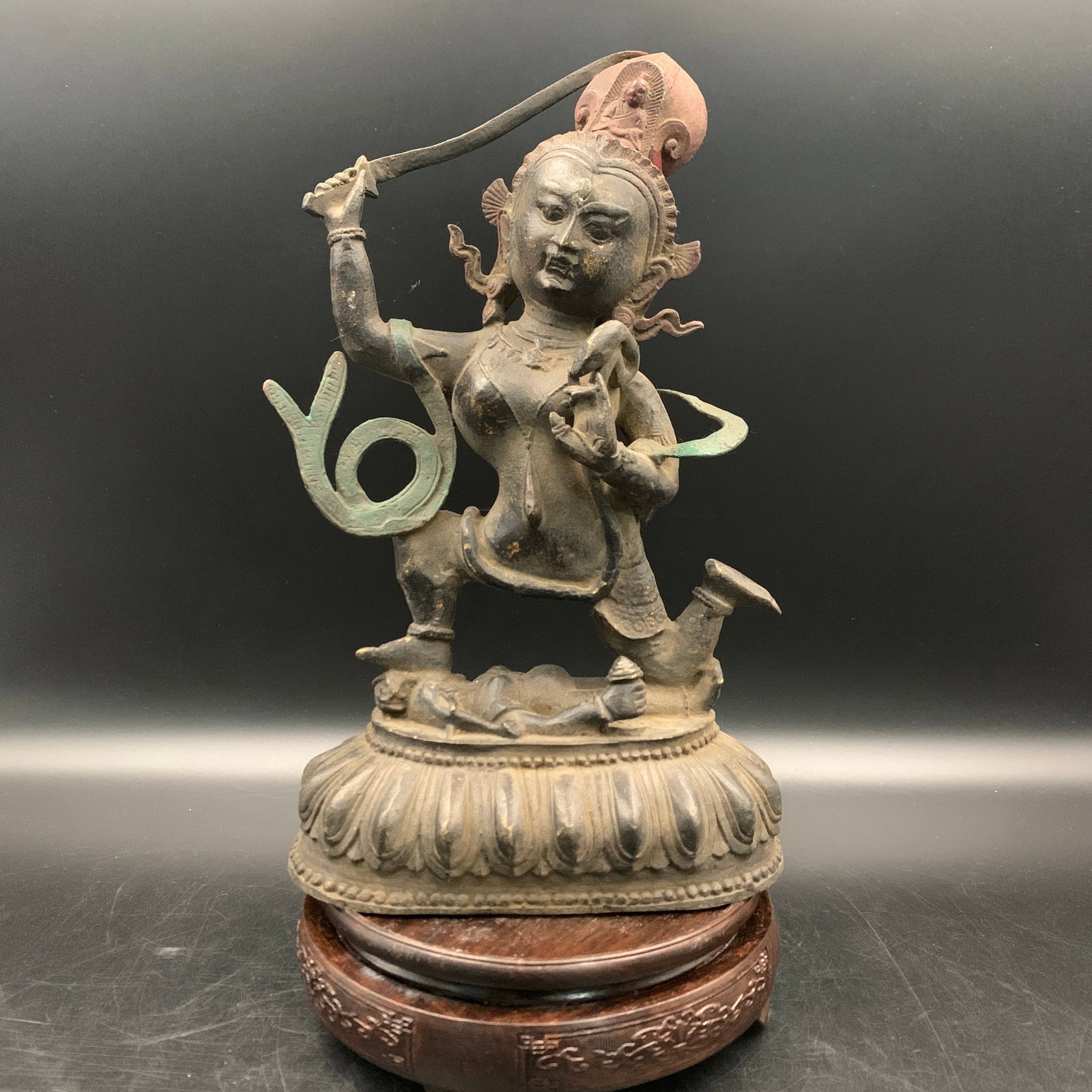 TIBETAN-STYLE BRONZE FIGURE OF A DANCING DAKINI ON A LOTUS THRONE: Ming Dynasty Style; Long: 6.6 inch; Width: 3.6 inch; High: 11 inch; ;Wooden base for picture and display only.