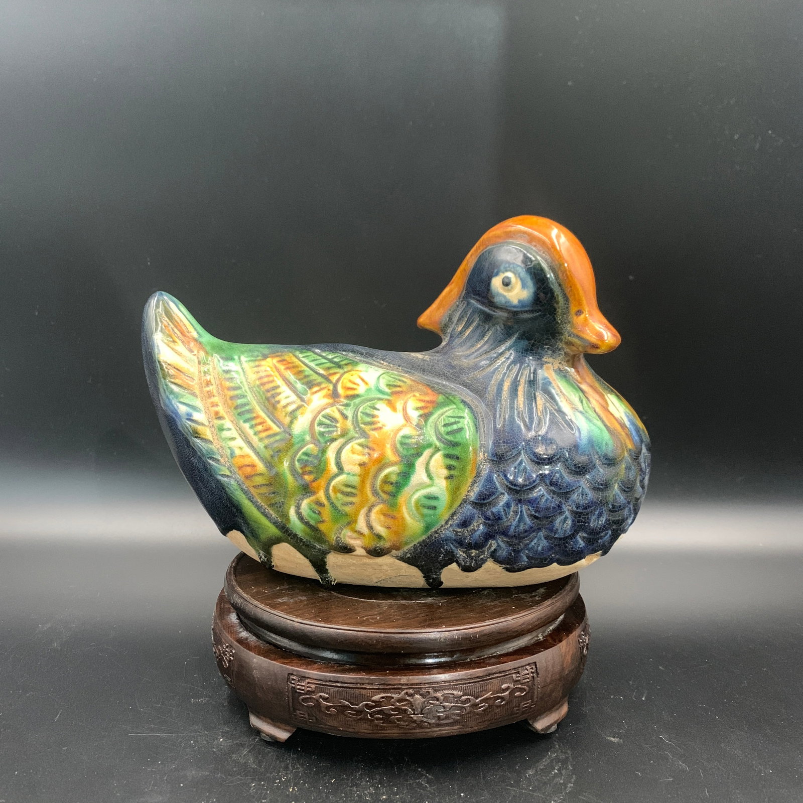 A SANCAI-GLAZED POTTERY FIGURE OF A MANDARIN DUCK: Song Dynasty Style; High: 8.9 inch; Diameter: 4.7 inch; ;Wooden base for picture and display only.