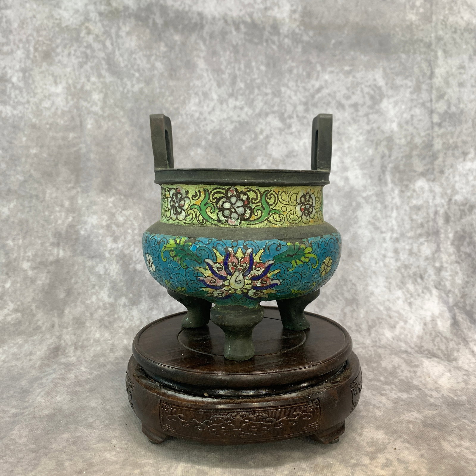 A CLOISONNE ENAMEL TRIPOD CENSER (DING) WITH U-SHAPED HANDLES: Qing Dynasty; High: 6.2 inch; Diameter: 5.6 inch; ;Wooden base for picture and display only.