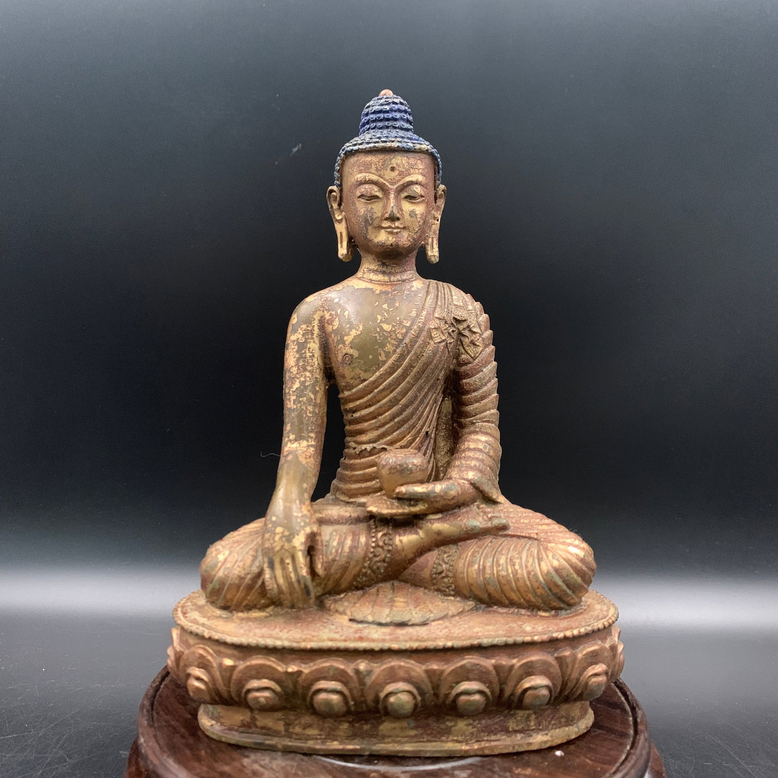 RARE PARTIALLY GILT BRONZE FIGURE OF MEDICINE BUDDHA SEATED ON A LOTUS BASE: Qing Dynasty; Long: 5.2 inch; Width: 3.3 inch; High: 7.6 inch; ;Wooden base for picture and display only.