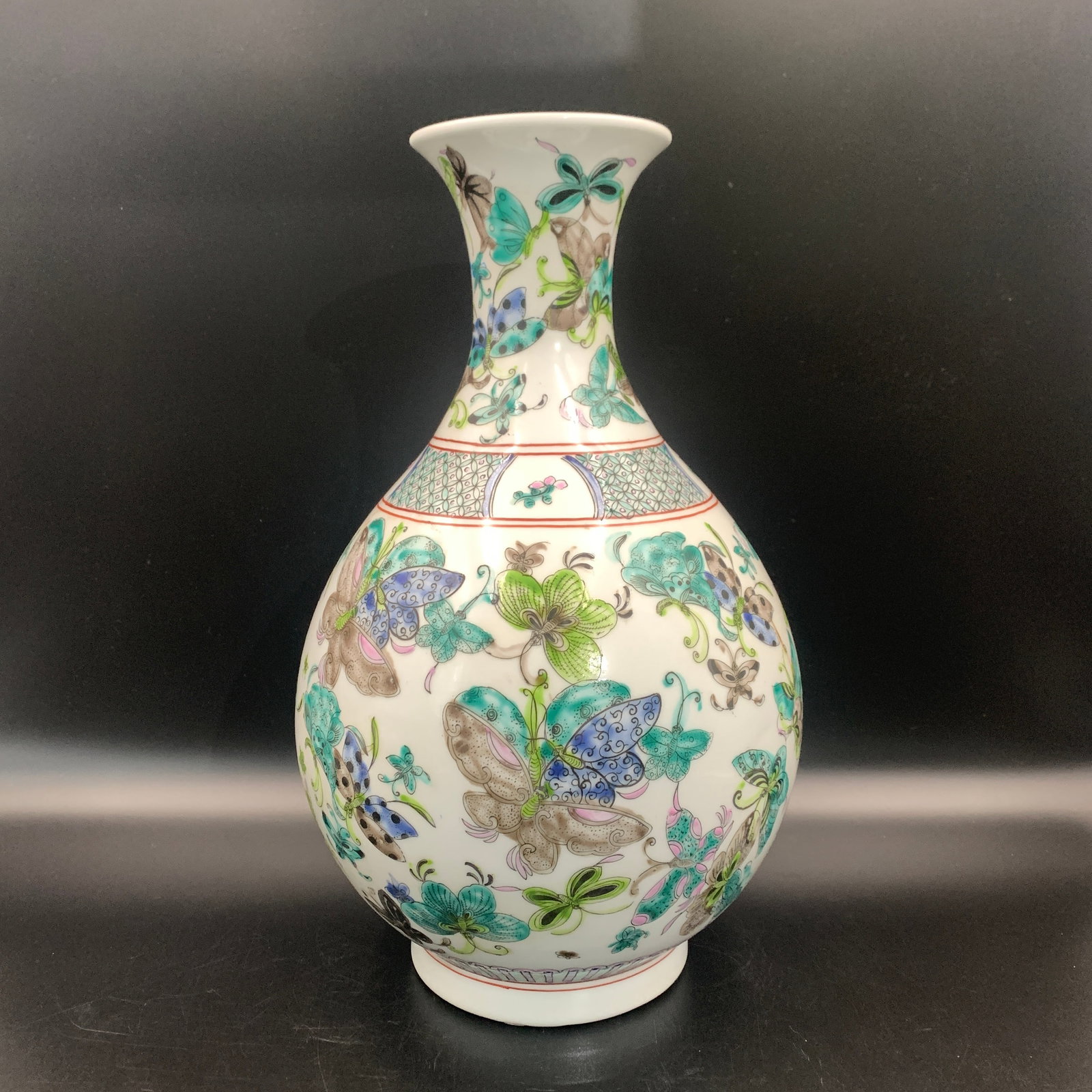 A FAMILLE-ROSE 'HUNDRED BUTTERFLIES' PORCELAIN BOTTLE VASE: Qing Dynasty; High: 15.2 inch; Diameter: 9.2 inch; ;Wooden base for picture and display only.