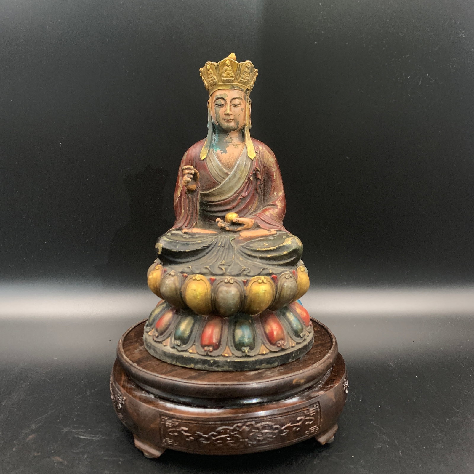A POLYCHROME AND GILT-BRONZE FIGURE OF KSITIGARBHA BODHISATTVA ON A LOTUS THRONE: Ming Dynasty Style; Long: 4.8 inch; Width: 4.6 inch; High: 7.8 inch; ;Wooden base for picture and display only.