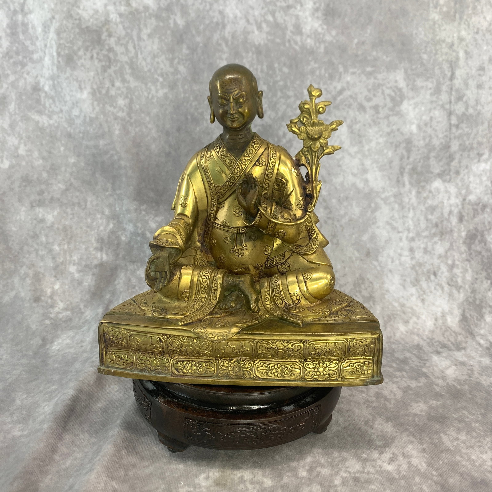 TIBETAN GILT-BRONZE FIGURE OF A SEATED ARHAT OR TIBETAN LAMA: Ming Dynasty Style; Long: 7.8 inch; Width: 4.4 inch; High: 8.2 inch; ;Wooden base for picture and display only.