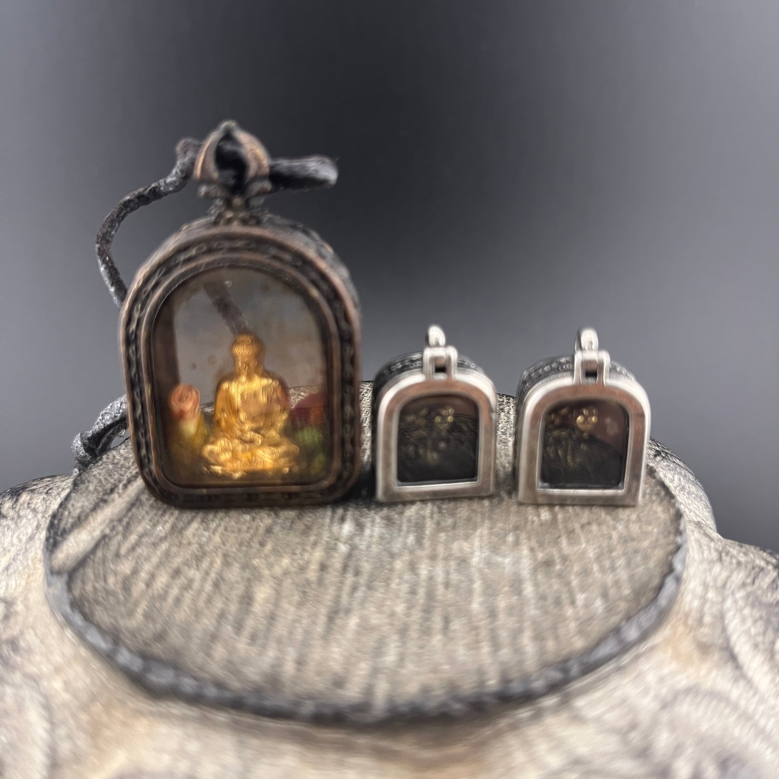 BUDDHIST GILT BUDDHA & RELIC PROTECTION AMULETS: Modern; Long: 1.7 inch; Width: 1 inch; High: 0.5 inch; Long: 0.8 inch; Width: 0.85 inch; High: 0.36 inch; . Wooden base for display only