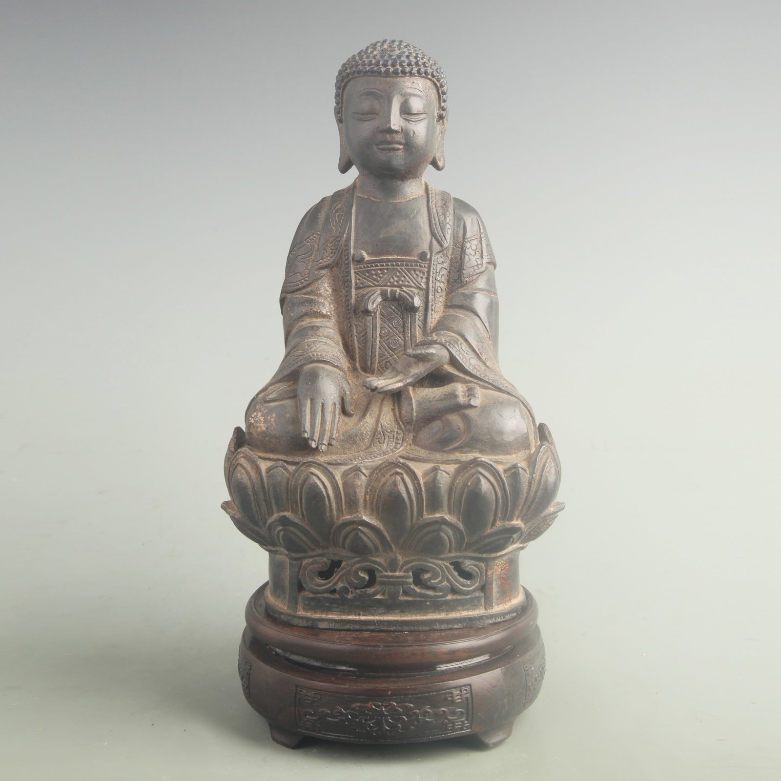 A GILT BRONZE SHAKYAMUNI BUDDHA: 19th Century; High: 10.0 inch; Width: 5.80 inch; . Wooden base for display only