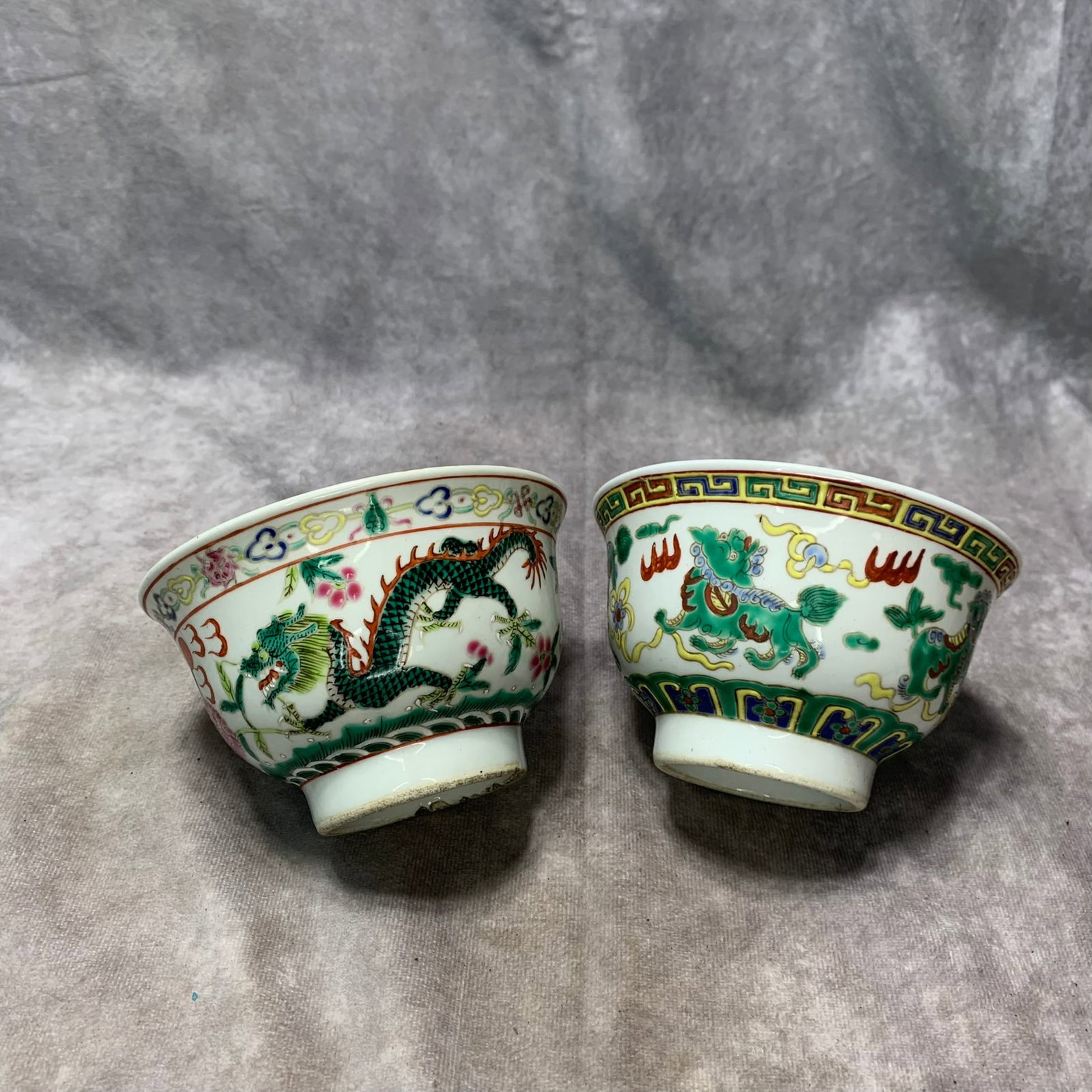 PAIR OF FAMILLE-ROSE AUSPICIOUS BEAST BOWLS WITH QIANLONG MARK: Qing Dynasty; H; 3.1???.1 inch; Diameter: 4.9???.9 inch. Wooden base for display only