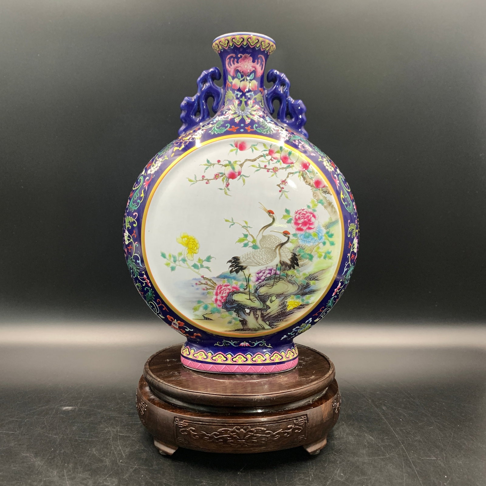 FAMILLE ROSE PORCELAIN MOONFLASK WITH CRANES AND PEONIES: Republic Period; Long: 7.6 inch; Width: 3.5 inch; High: 10.3 inch; . Wooden base for display only