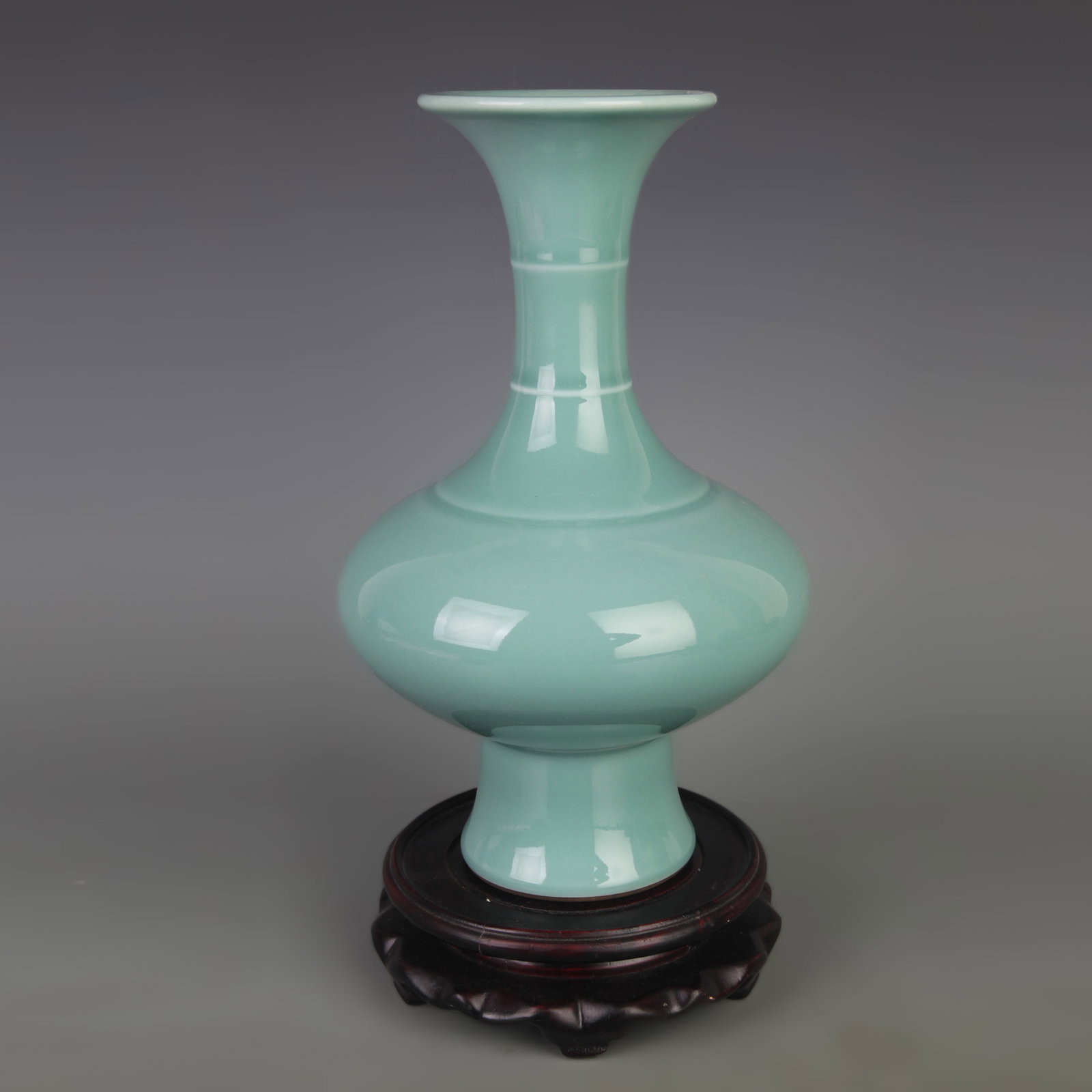 AN LONGQUAN CELADON GLAZED PORCELAIN VASE: Qing Dynasty Qian Long Period; Diameter: 5.8 inch; High: 9.3 inch. Wooden base for display only