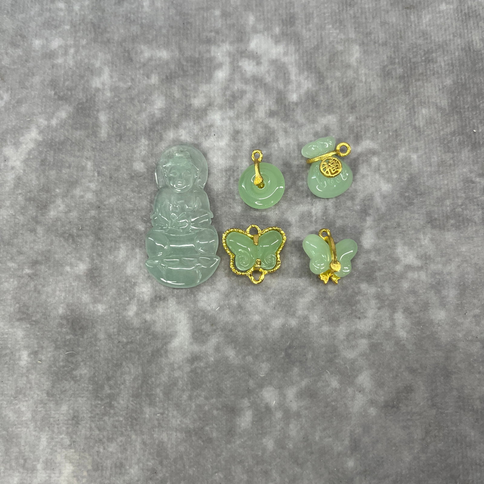 GROUP OF JADE GUAN YIN NECKLACE PENDANT AND BUTTERFLY EARRINGS: Modern; Long: 1.54 inch; Width: 0.75 inch; High: 0.12 inch. Wooden base for display only