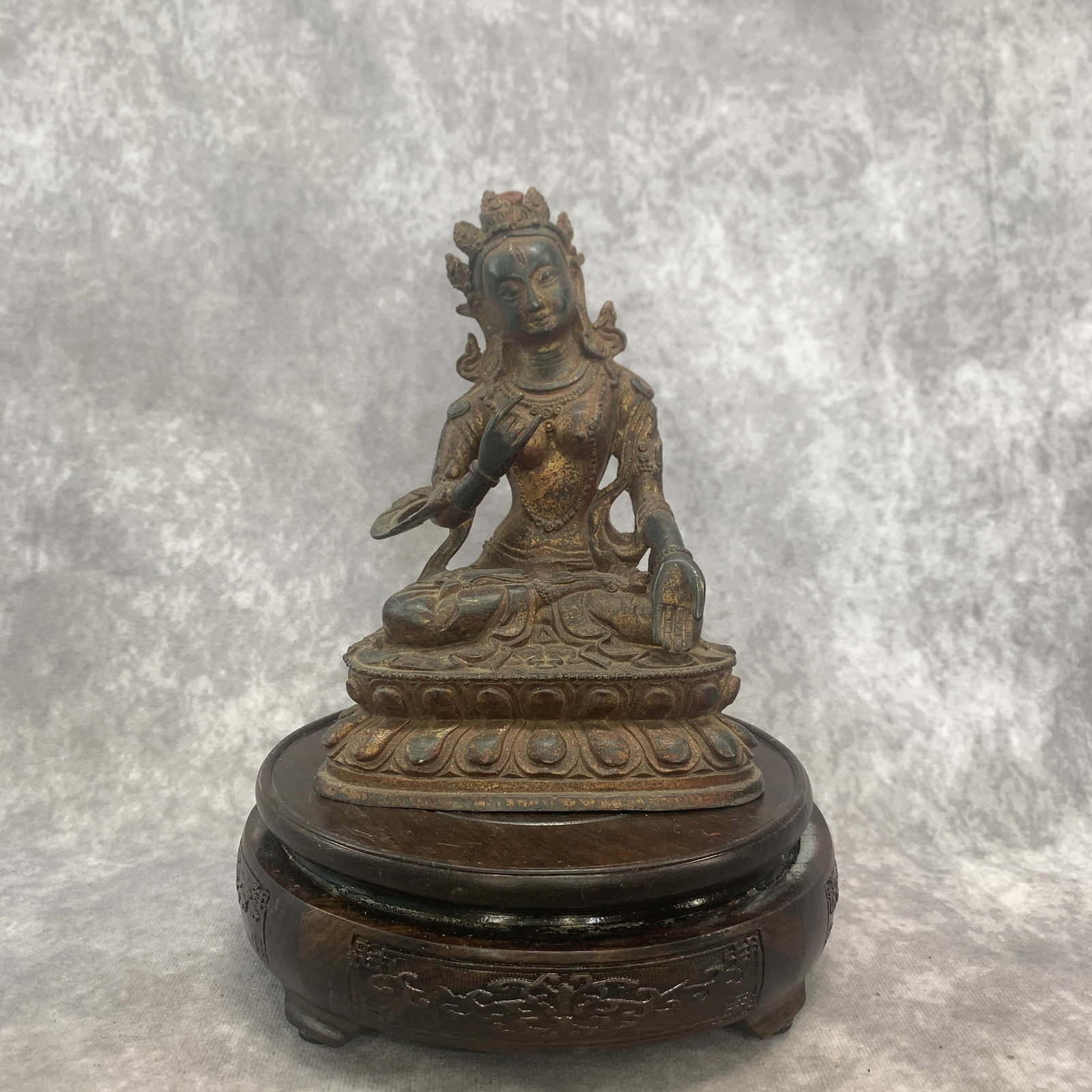 A SMALL TIBETAN PATINATED BRONZE STATUE OF GREEN TARA: Qing Dynasty; Long: 4.7 inch; Width: 2.7 inch; High: 6.4 inch; . Wooden base for display only