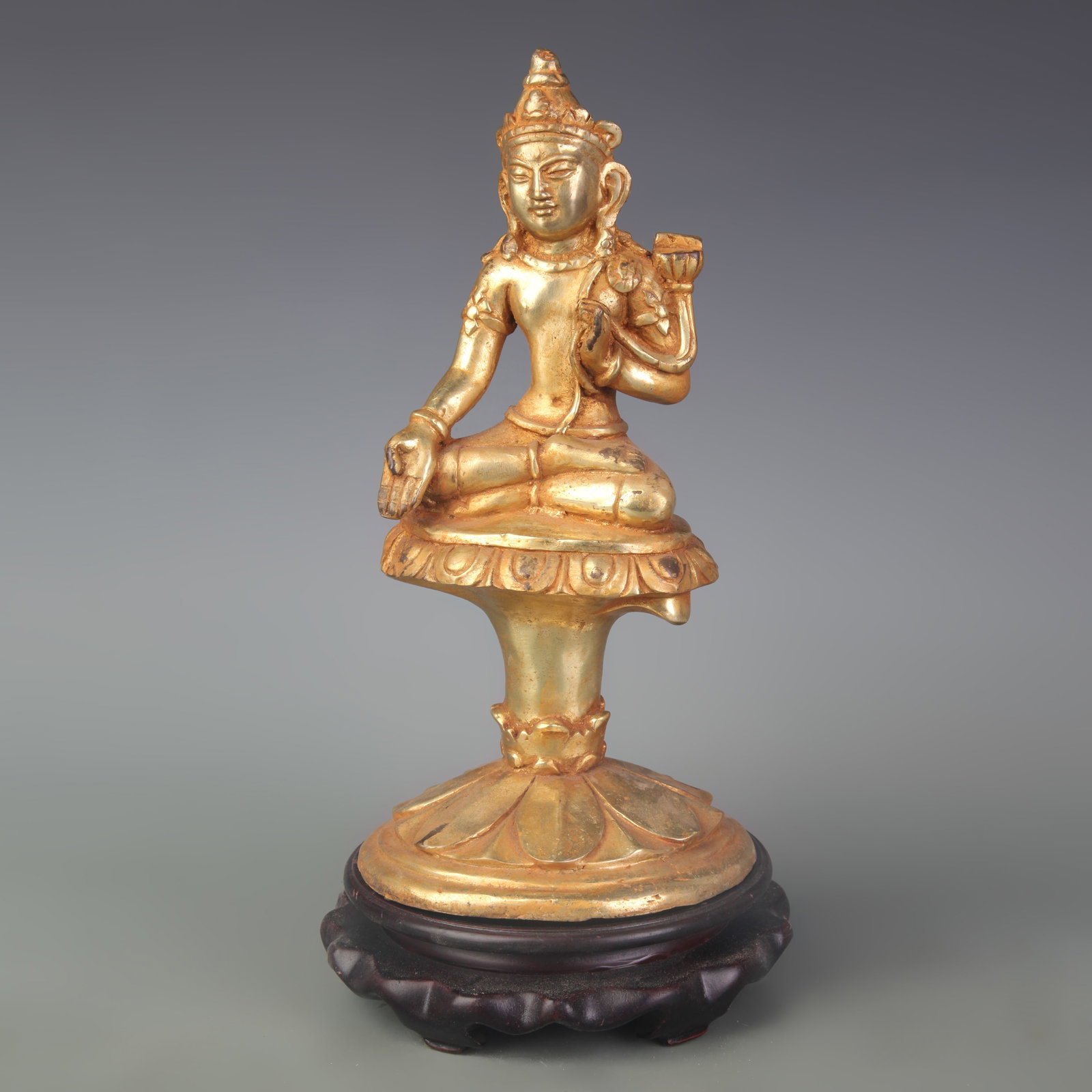 TIBETAN STYLE GILT BRONZE STATUE OF A SEATED BODHISATTVA: Qing Dynasty; Width: 4.8 inch; High: 9.4 inch; . Wooden base for display only