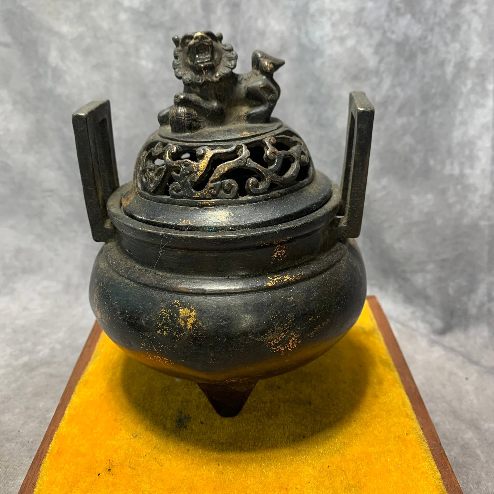 XUANDE ERA THREE-LEGGED CENSER WITH LION LID AND DRAGON PATTERNS: Ming Dynasty Style; High: 6 inch; Diameter: 4.5 inch; . Wooden base for display only