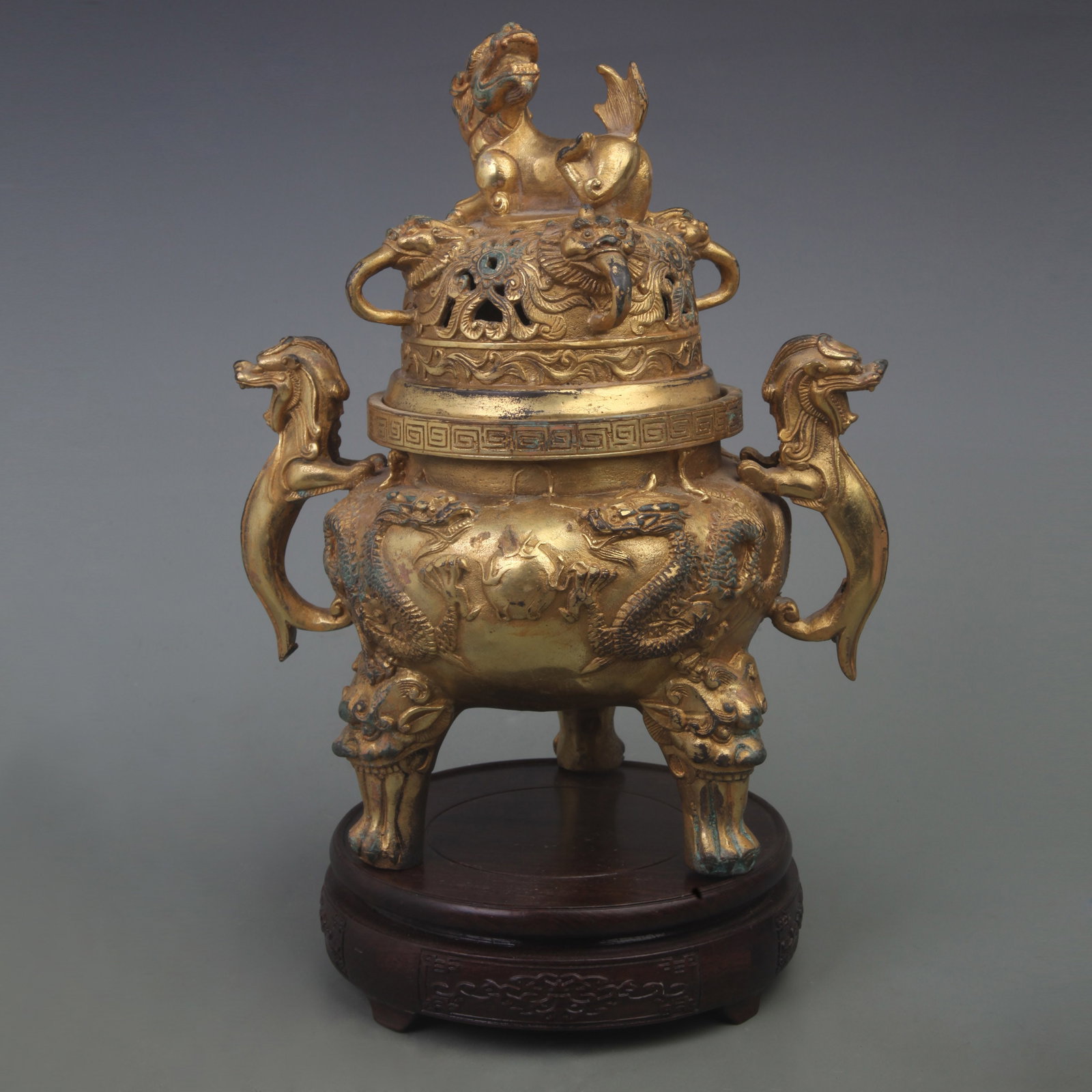 A FINE DRAGON PATTERN THREE FOOT INCENSE BURNER: Qing Dynasty; Diameter: 9.0 inch; High: 11.0 inch; . Wooden base for display only