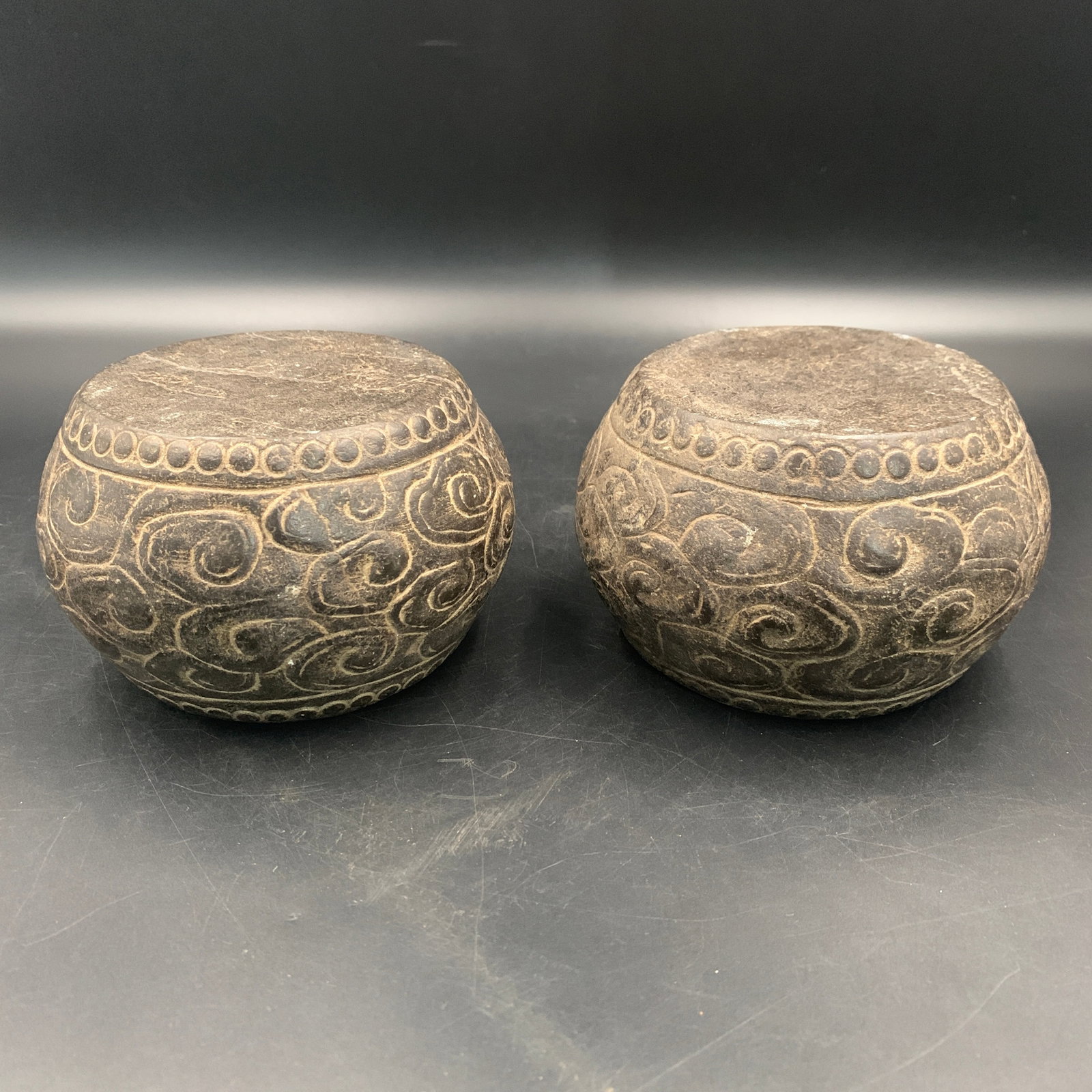 PAIR OF CARVED STONE CLOUD-SCROLL BASE: Modern; High: 3.3 inch; Diameter: 5.3 inch; . Wooden base for display only