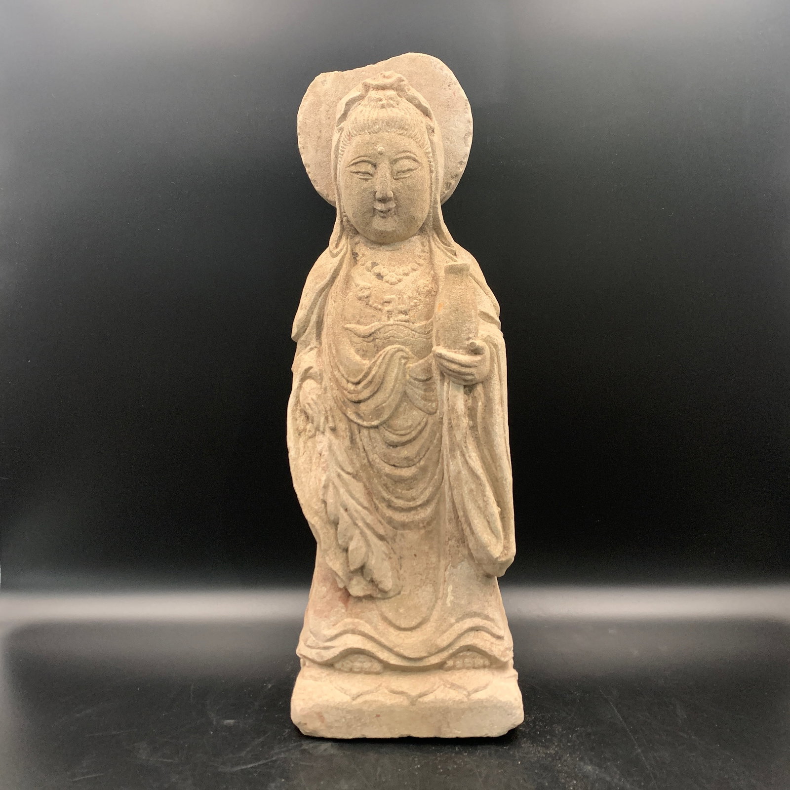 A FINE STANDING STONE GUANYIN STATUE