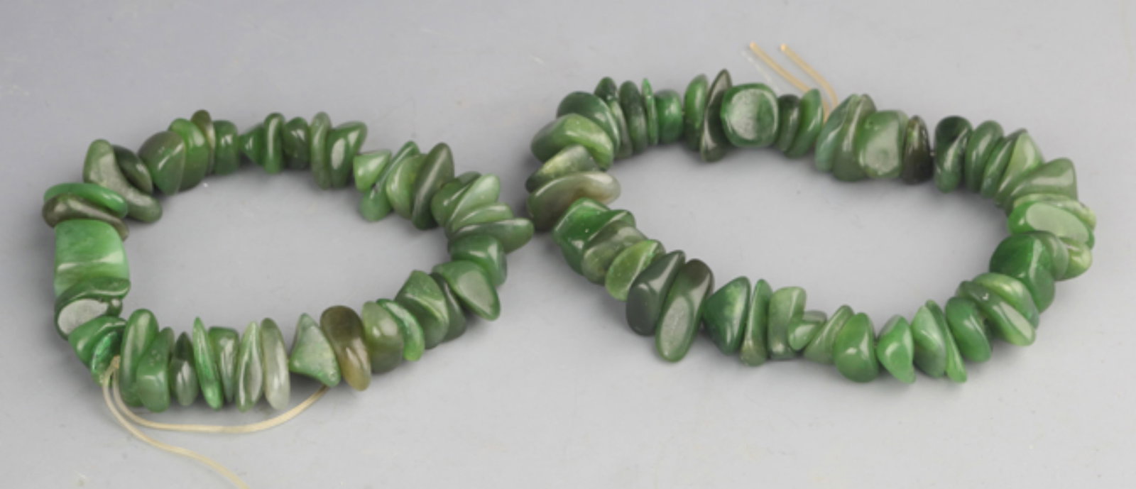 GROUP OF TWO FINE GREEN JADE BRACELETS