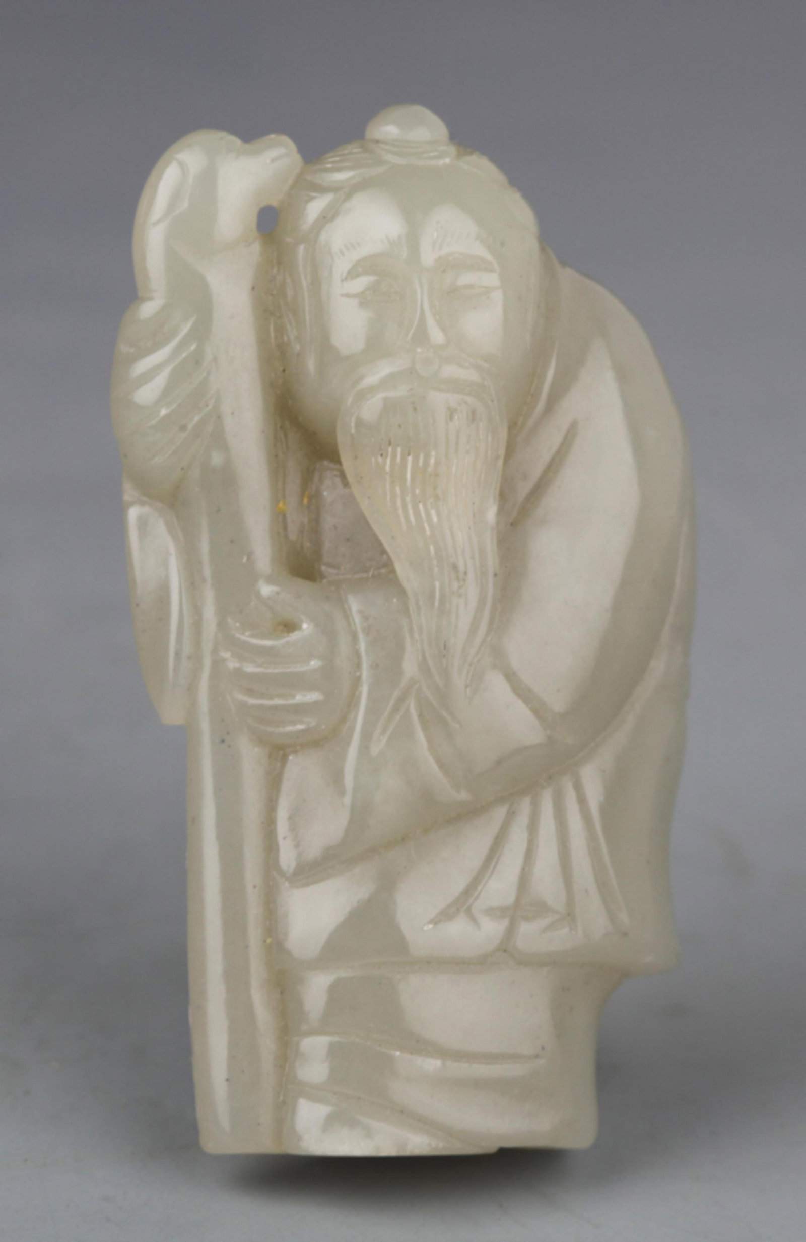 A FINELY CARVED PALE CELADON JADE PENDANT PENDANT IN FIGURE